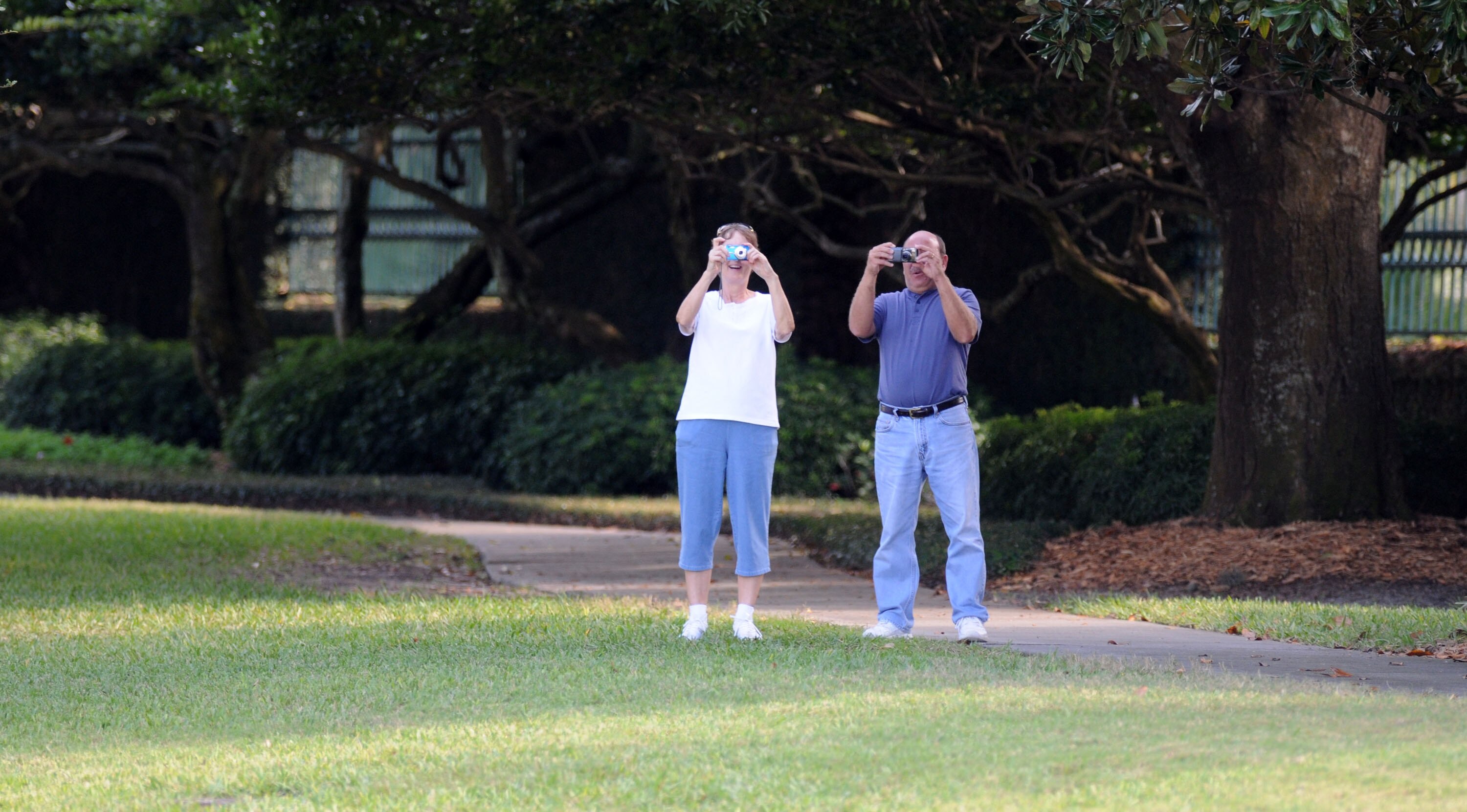WINDERMERE, FL - NOVEMBER 30:   People take pictures from the gate of the Isleworth community, which is home to Tiger Woods, on November 30, 2009 in Windermere, Florida. Tiger Woods has not spoken with media or Florida Highway Patrol since he drove his SU