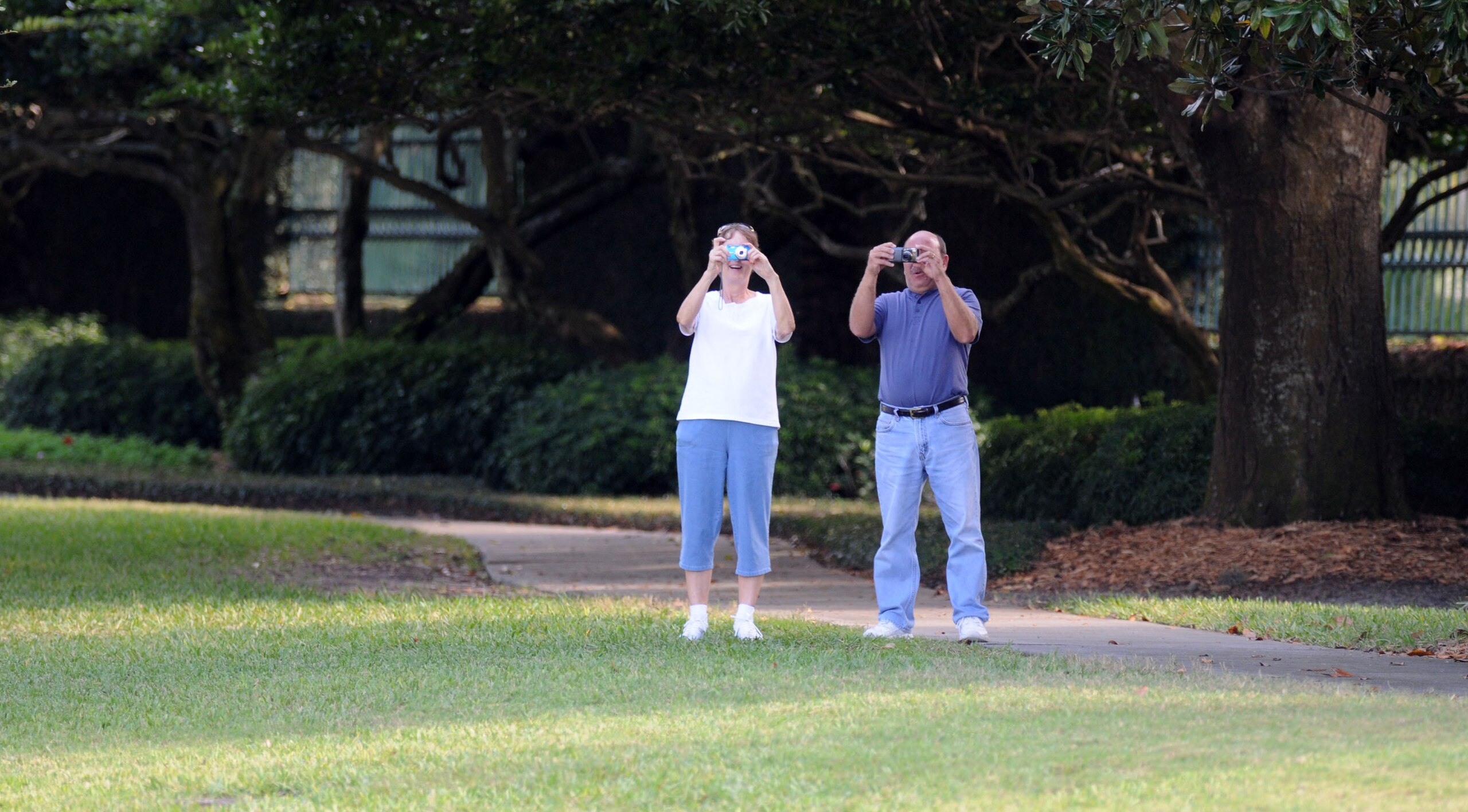WINDERMERE, FL - NOVEMBER 30:   People take pictures from the gate of the Isleworth community, which is home to Tiger Woods, on November 30, 2009 in Windermere, Florida. Tiger Woods has not spoken with media or Florida Highway Patrol since he drove his SU