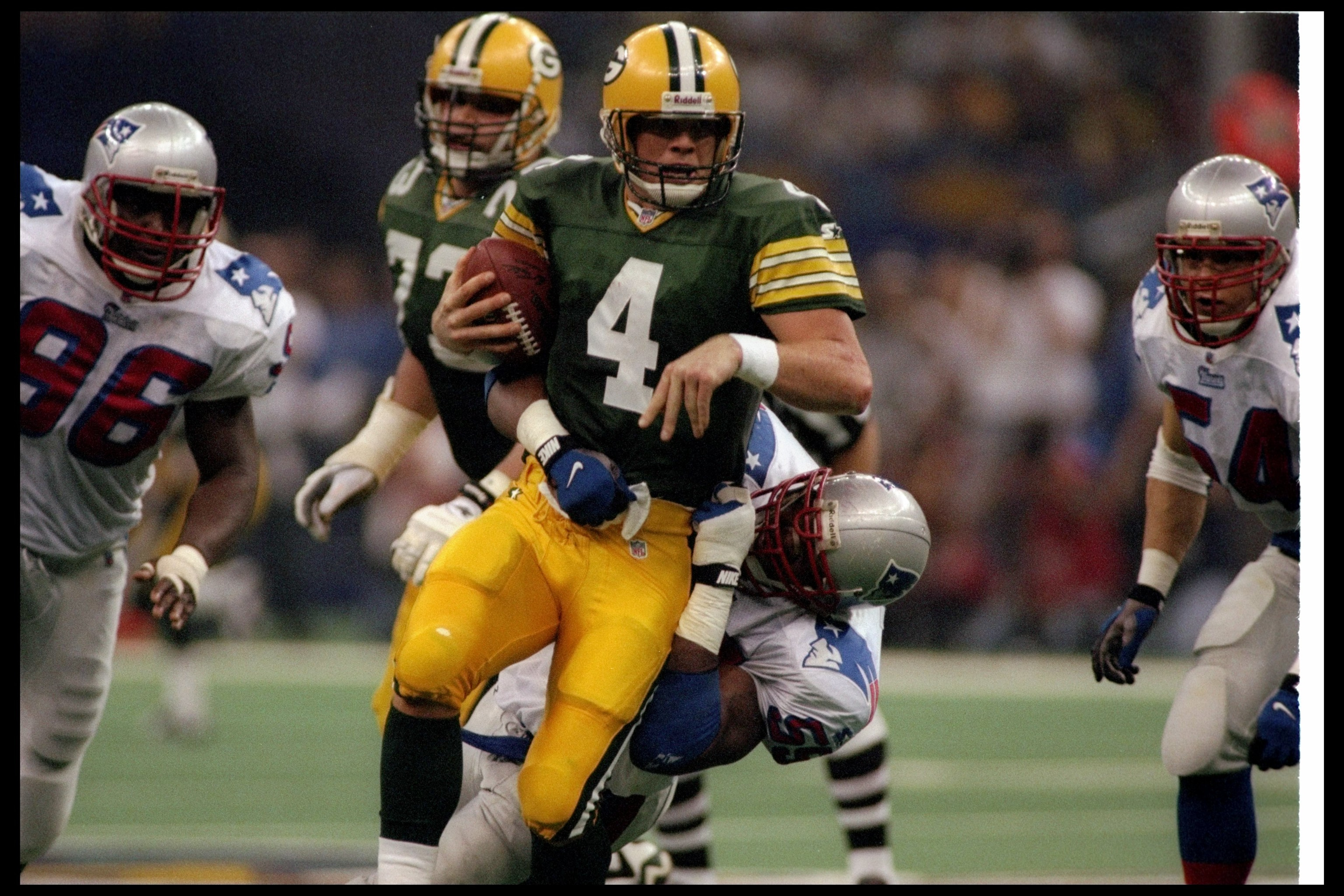 26 Jan 1997:  Quarterback Brett Favre of the Green Bay Packers gets sacked by New England Patriots defensive lineman Mike Jones during Super Bowl XXXI at the Superdome in New Orleans, Louisiana.  The Packers won the game, 35-21. Mandatory Credit: Rick Ste