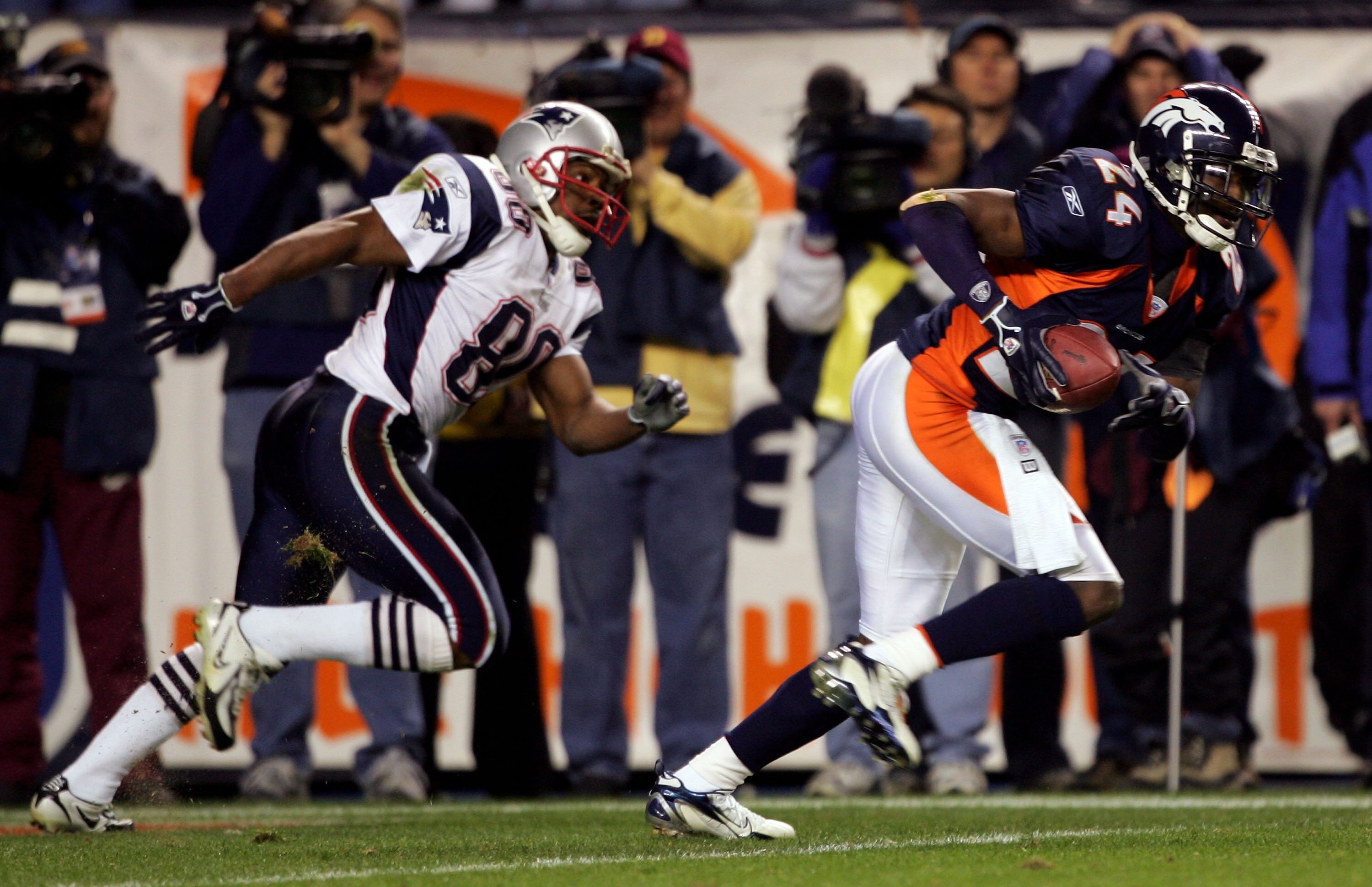 DENVER - JANUARY 14:  Cornerback Champ Bailey #24 of the Denver Broncos intercepts a pass in front of wide receiver Troy Brown #80 of the New England Patriots and returns it 100-yards before fumbling at the 1-yard yardline in the third quarter of the AFC