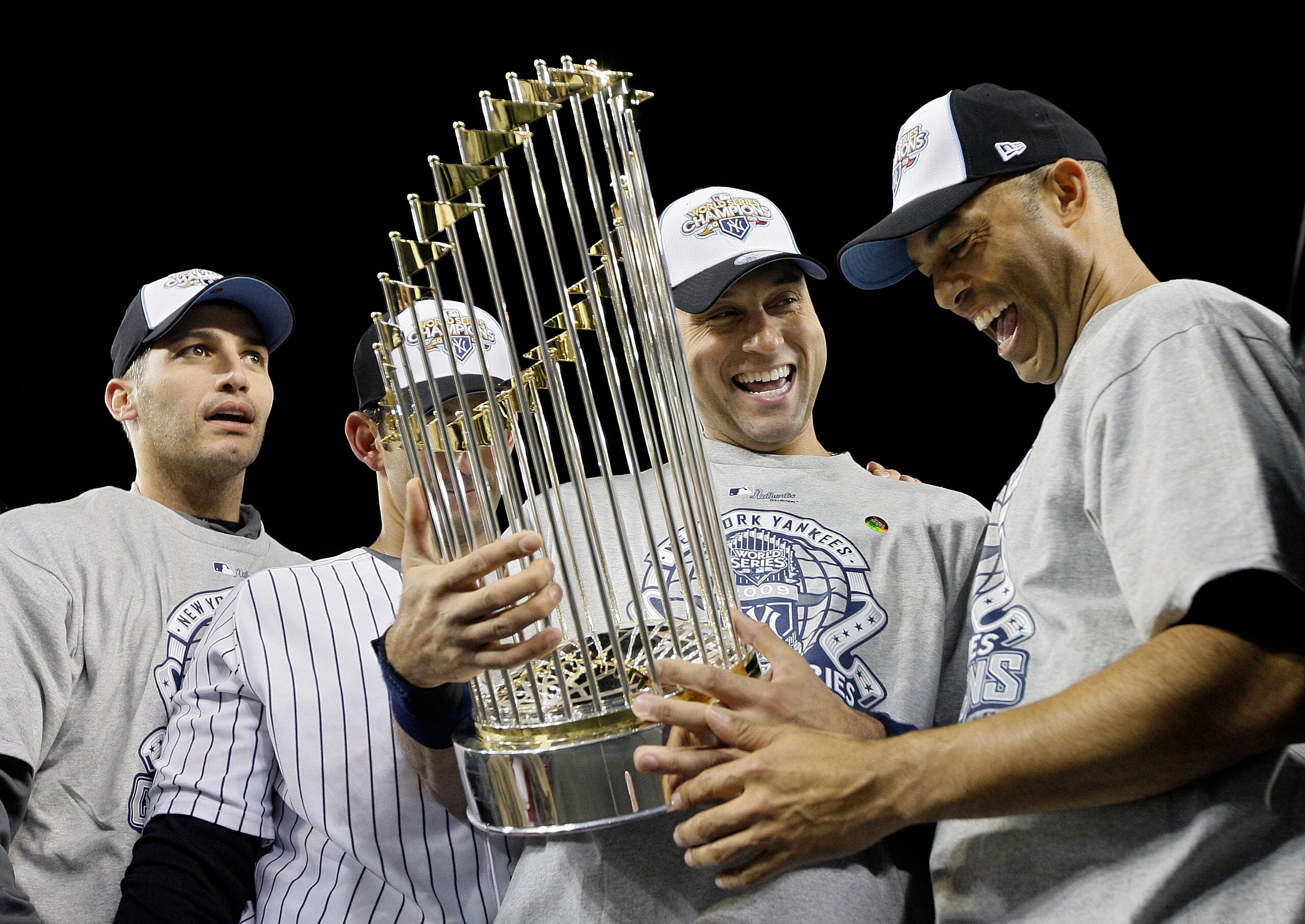 NEW YORK - NOVEMBER 04: (L-R) Andy Pettitte #46, Jorge Posada #20, Derek Jeter #2 and Mariano Rivera #42 of the New York Yankees celebrate with the trophy after their 7-3 win against the Philadelphia Phillies in Game Six of the 2009 MLB World Series at Y NEW YORK - NOVEMBER 04: (L-R) Andy Pettitte #46, Jorge Posada #20, Derek Jeter #2 and Mariano Rivera #42 of the New York Yankees celebrate with the trophy after their 7-3 win against the Philadelphia Phillies in Game Six of the 2009 MLB World Series at Y