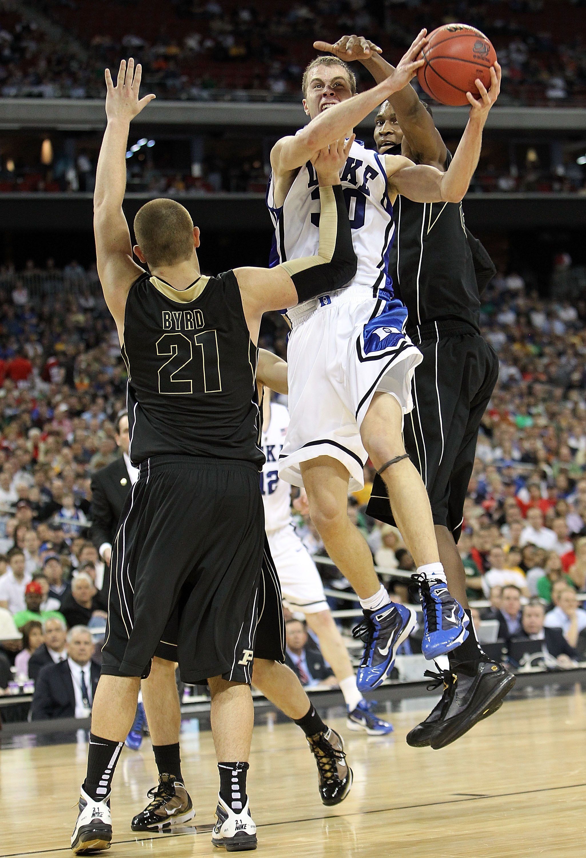 HOUSTON - MARCH 26:  Guard Jon Scheyer #30 of the Duke Blue Devils takes a shot against D.J. Byrd of the Purdue Boilermakers during the south regional semifinal of the 2010 NCAA men's basketball tournament at Reliant Stadium on March 26, 2010 in Houston,
