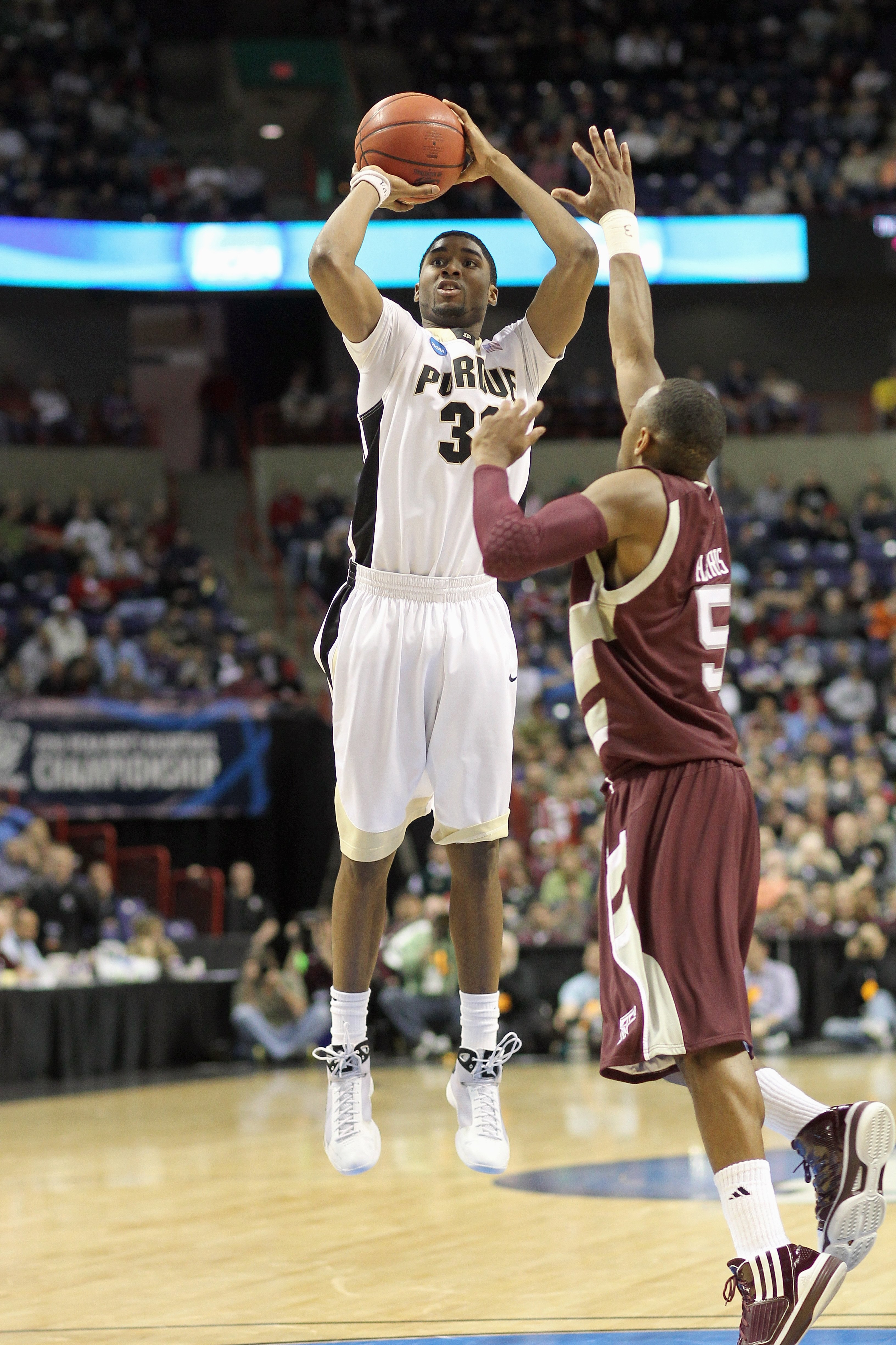 SPOKANE,WA - MARCH 21: E'Twaun Moore #33 of the Purdue Boilermakers makes a jumpshot against Dash Harris #5 of the Texas A&M Aggies during the second round of the 2010 NCAA men's basketball tournament at the Spokane Arena on March 21, 2010 in Spokane, Was