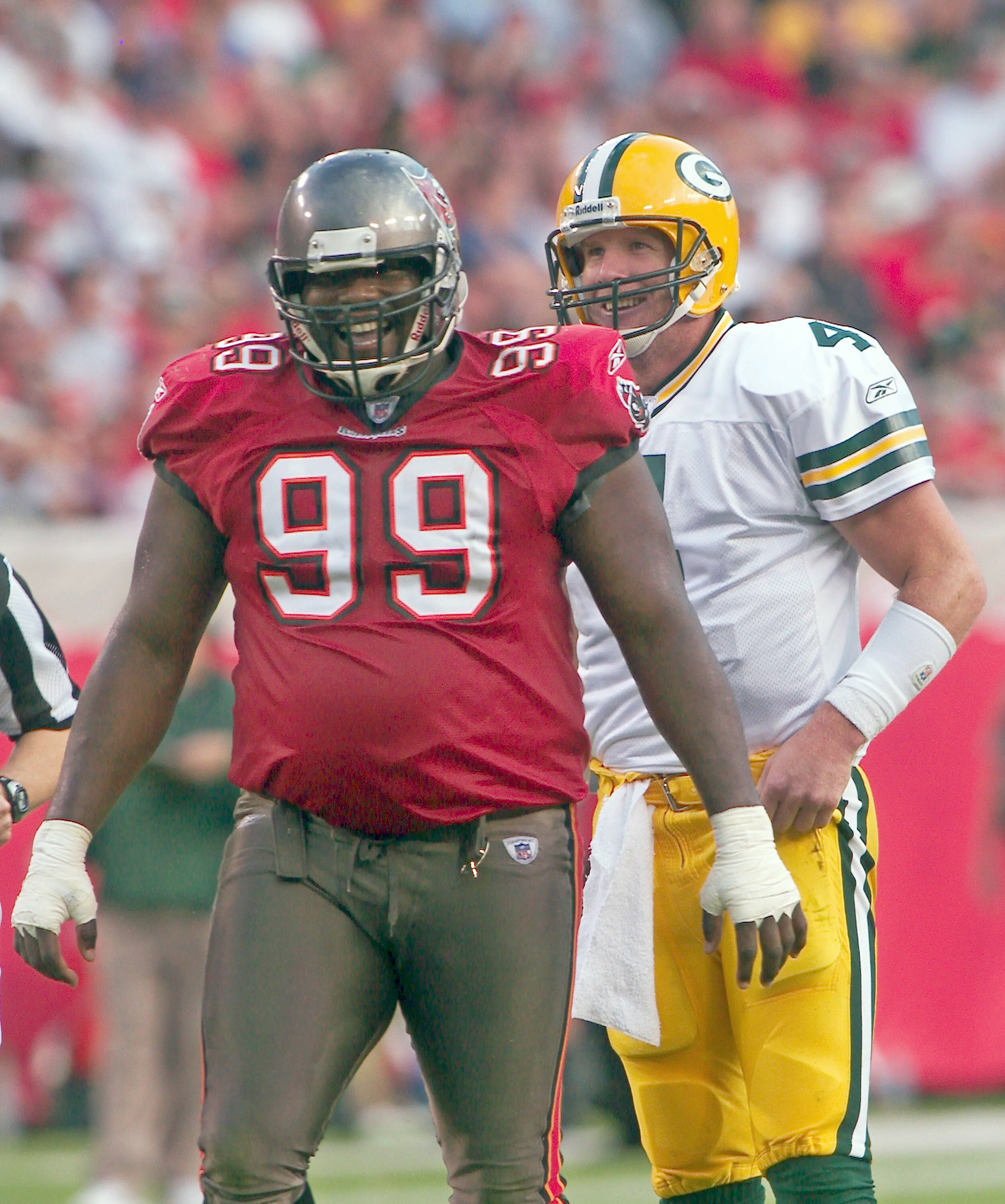 Tampa, FL - NOVEMBER 16:  Warren Sapp #99 of the Tampa Bay Buccaneers laughs with Brett Favre #4 of the Green Bay Packers at Raymond James Stadium, on November 16, 2003, in Tampa, Florida. (Photo by Matt Stroshane / Getty Images)