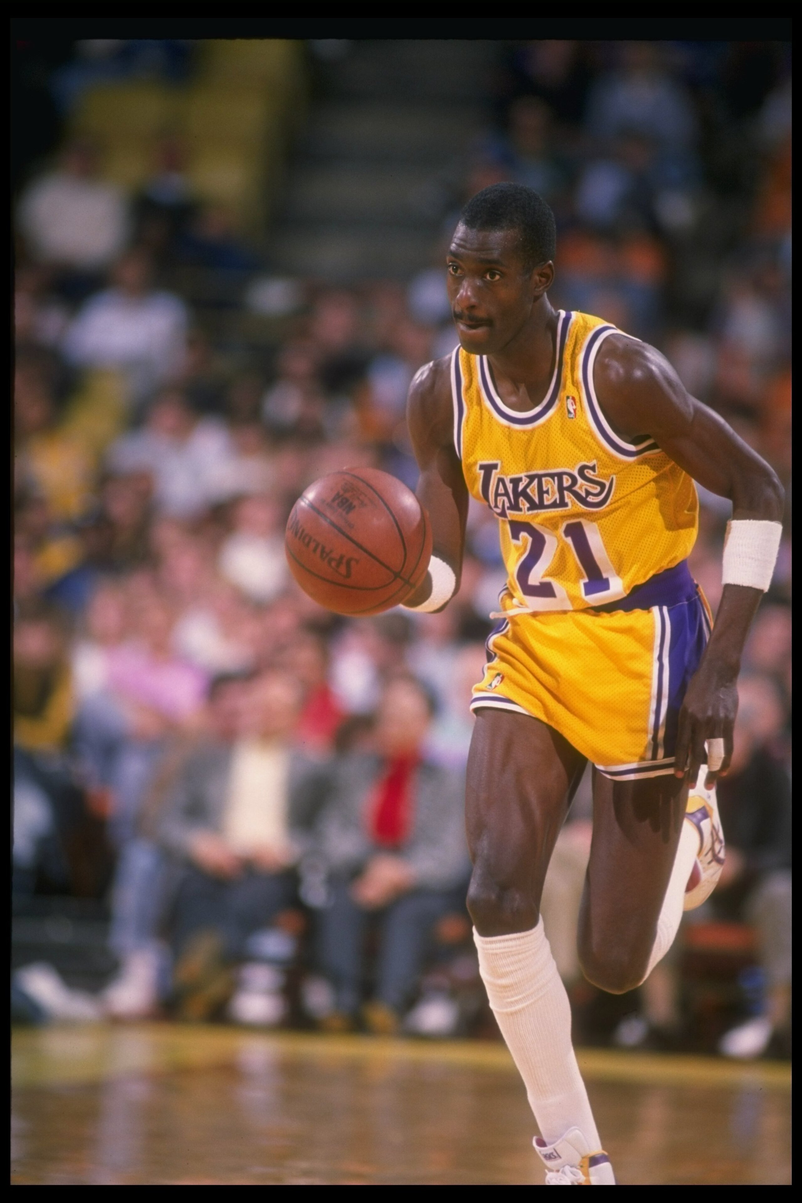 1988-1989:  Michael Cooper of the Los Angeles Lakers moves the ball during a game. Mandatory Credit: Mike Powell  /Allsport Mandatory Credit: Mike Powell  /Allsport