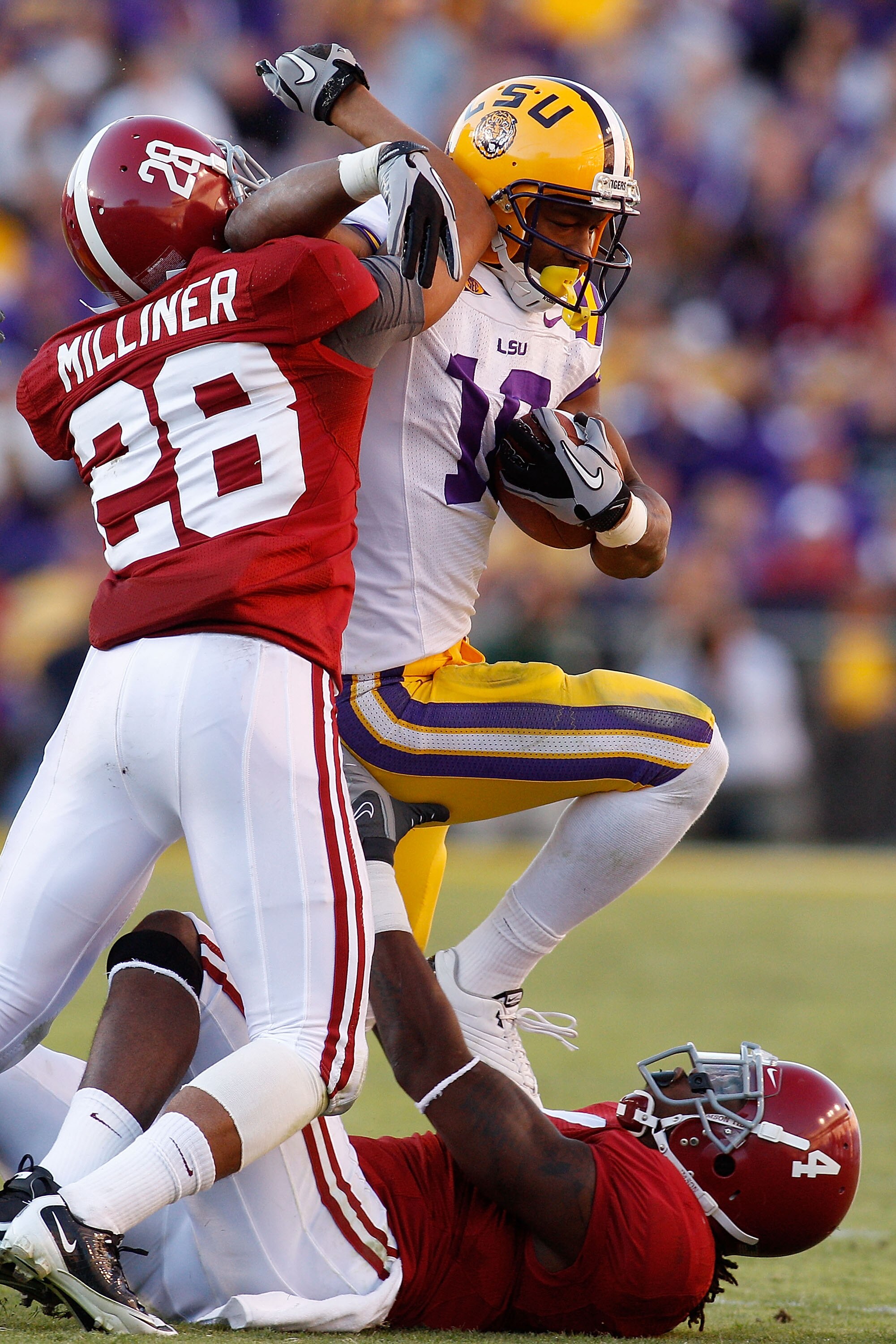BATON ROUGE, LA - NOVEMBER 06:  Richard Murphy #18 of the Louisiana State University Tigers is tackled by DeMarcus Milliner #28 and Mark Barron #4 of the Alabama Crimson Tide at Tiger Stadium on November 6, 2010 in Baton Rouge, Louisiana. The Tigers defea