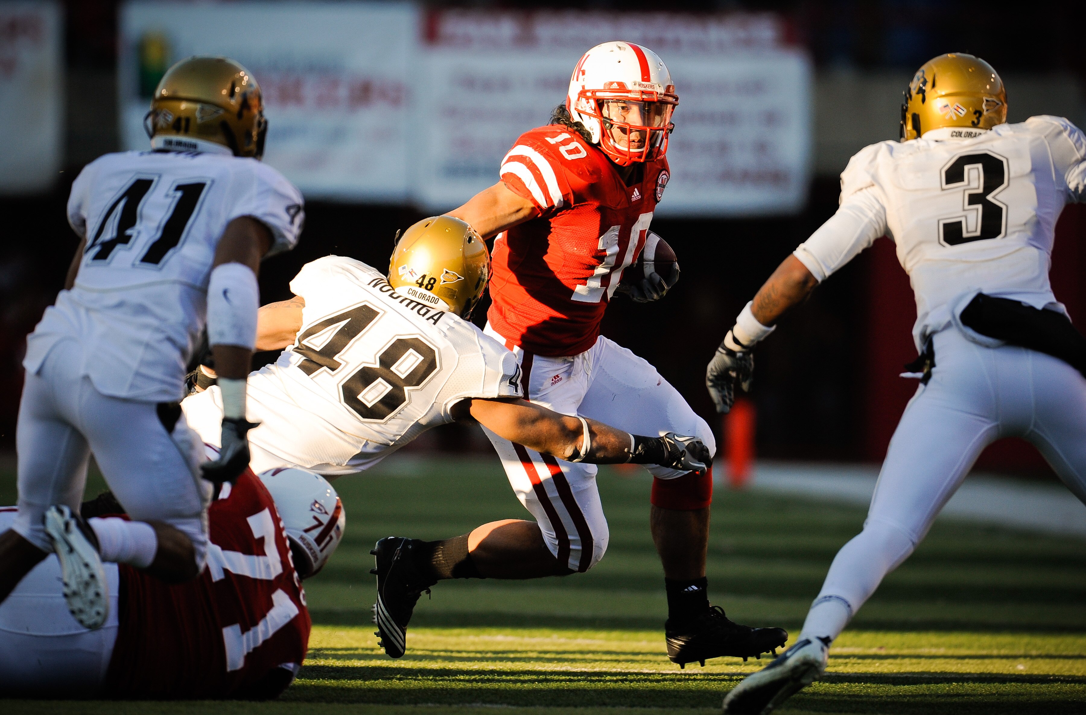 LINCOLN, NE - NOVEMBER 26: Roy Helu Jr. #10 of the Nebraska Cornhuskers runs through the Colorado Buffalo defense during the first half of their game at Memorial Stadium on November 26, 2010 in Lincoln, Nebraska. Nebraska defeated Colorado 45-17. (Photo b
