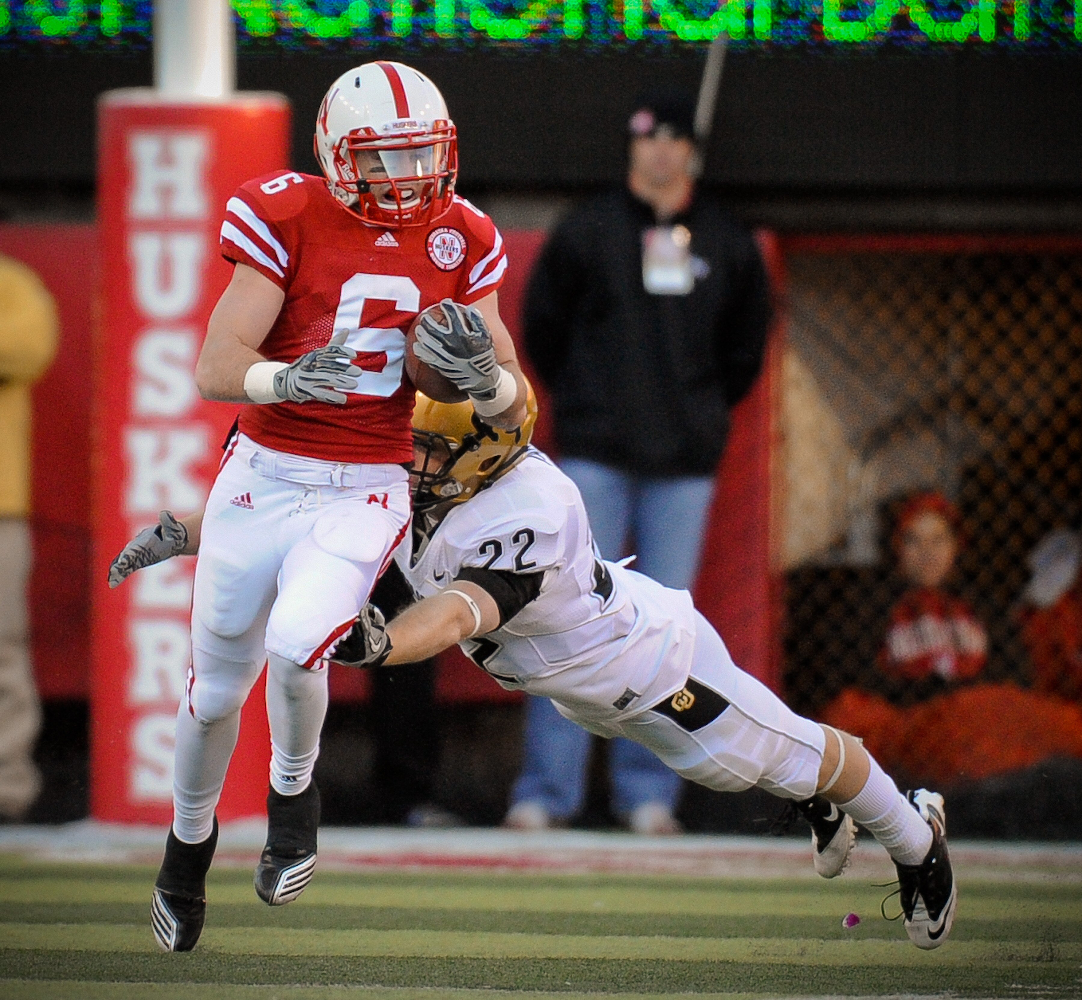 LINCOLN, NE - NOVEMBER 26: Tim Marlowe #6 of the Nebraska Cornhuskers returns a kickoff past Arthur Jaffee #22 of the Colorado Buffaloes during the first half of their game at Memorial Stadium on November 26, 2010 in Lincoln, Nebraska.  Nebraska defeated