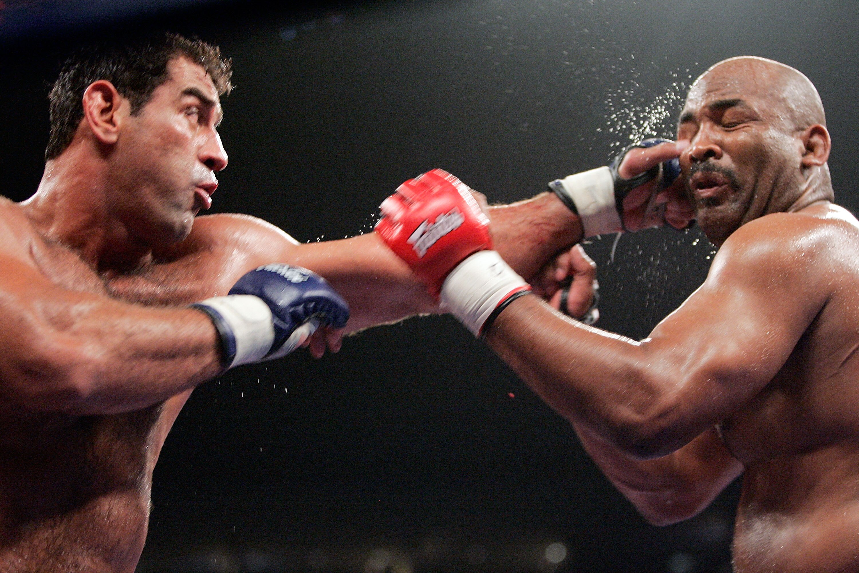 HOFFMAN ESTATES, IL - MAY 19:  Marco Ruas (L) of the Southern California Condors punches Maurice Smith of the Seattle Tiger Sharks during their superfight on May 19, 2007 at the Sears Centre in Chicago, Illinois.  (Photo by Brian Bahr/Getty Images for IFL