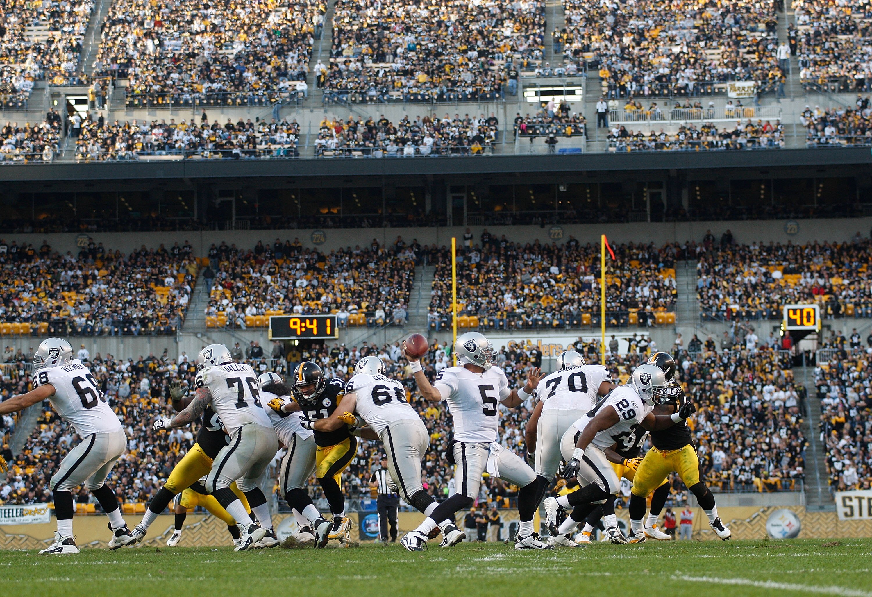 PITTSBURGH - NOVEMBER 21:  Bruce Gradkowski #5 of the Oakland Raiders drops back to pass during the game against the Pittsburgh Steelers on November 21, 2010 at Heinz Field in Pittsburgh, Pennsylvania.  (Photo by Jared Wickerham/Getty Images)