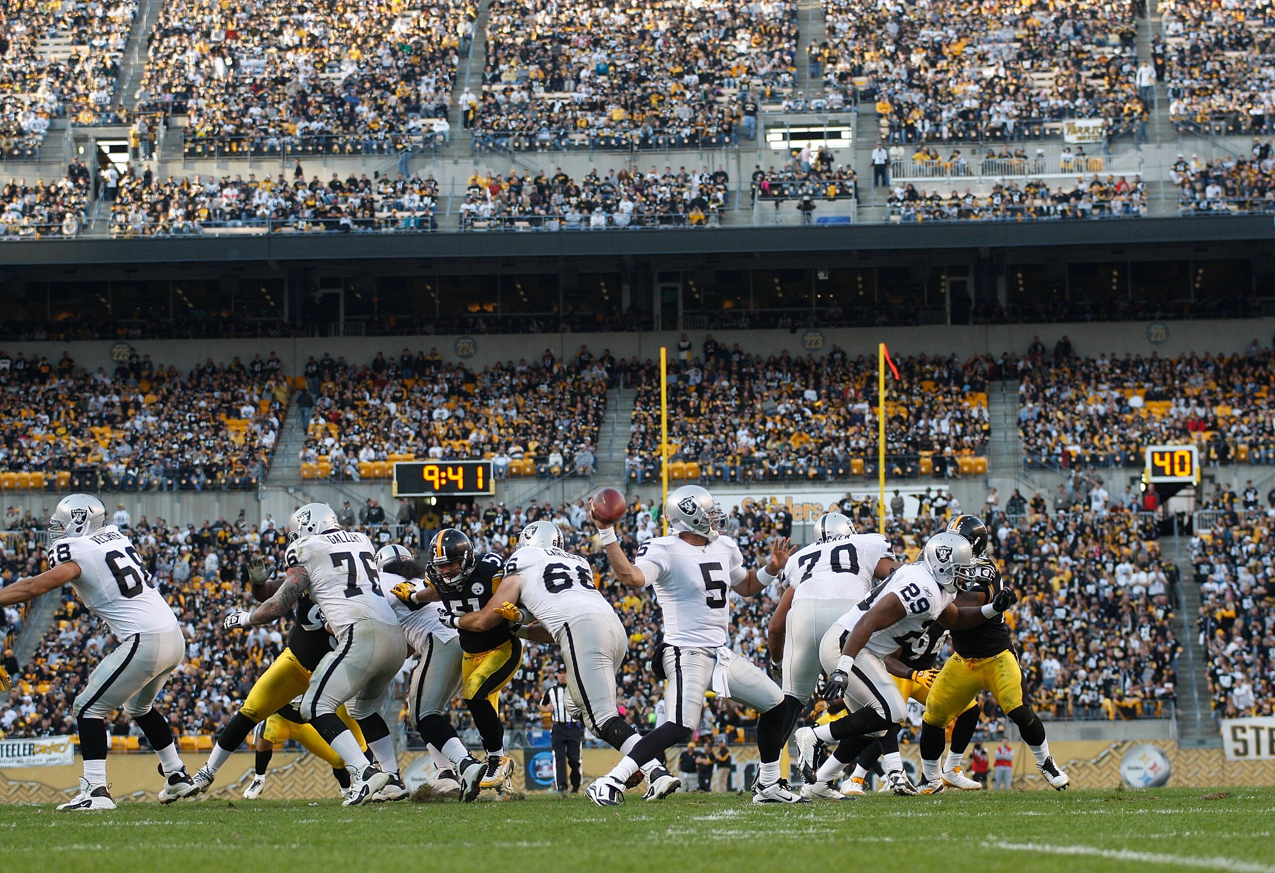 PITTSBURGH - NOVEMBER 21:  Bruce Gradkowski #5 of the Oakland Raiders drops back to pass during the game against the Pittsburgh Steelers on November 21, 2010 at Heinz Field in Pittsburgh, Pennsylvania.  (Photo by Jared Wickerham/Getty Images)