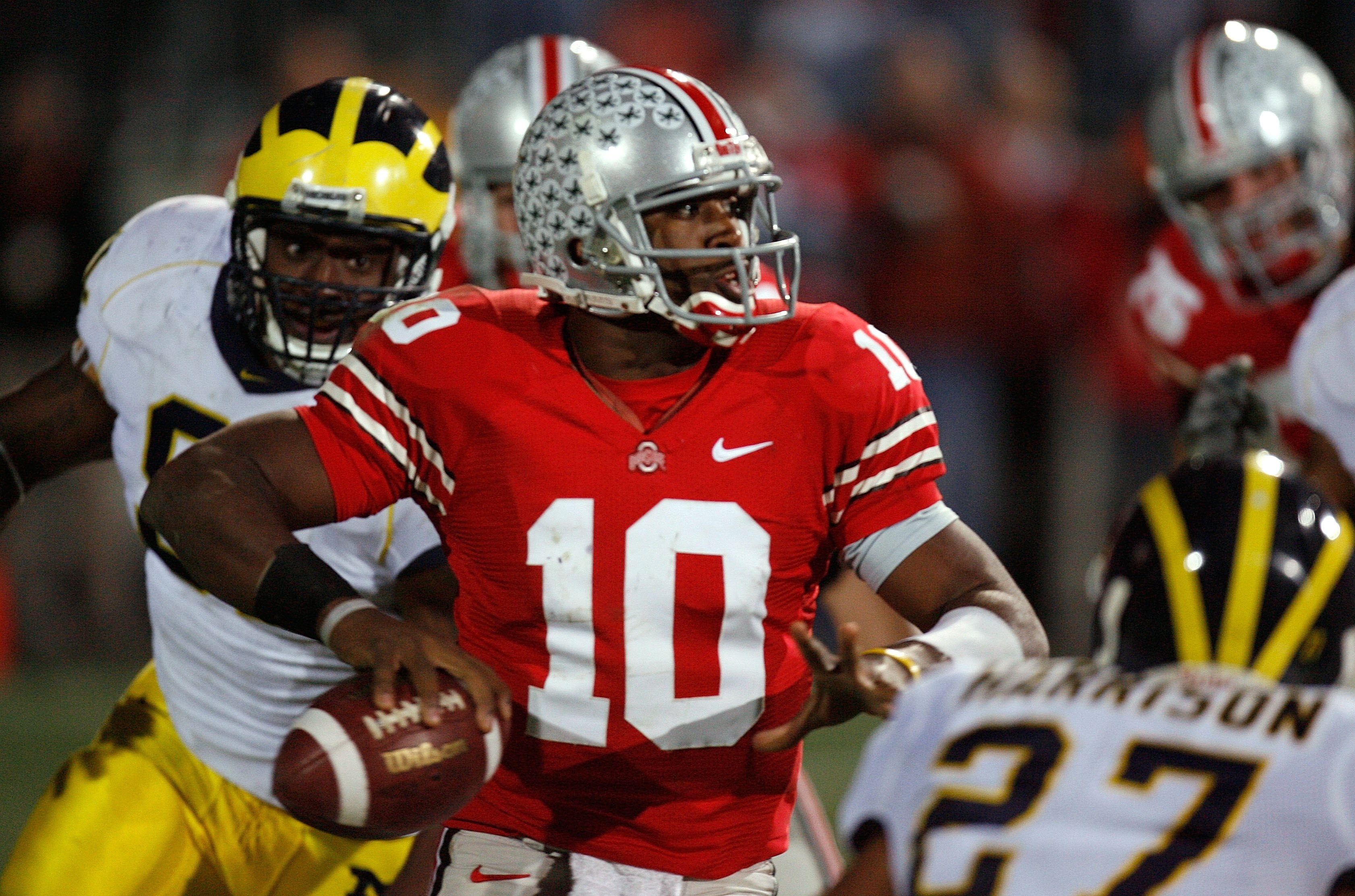 COLUMBUS, OH - NOVEMBER 18:  Quarterback Troy Smith #10 of the Ohio State Buckeyes throws a 3 quarter interception under pressure from the Michigan Wolverines defense November 18, 2006 at Ohio Stadium in Columbus, Ohio.  (Photo by Gregory Shamus/Getty Ima