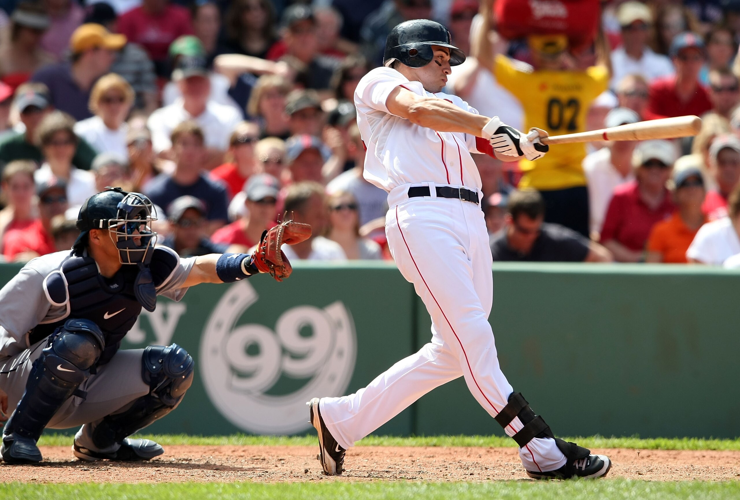 BOSTON - JULY 05:  Jacoby Ellsbury #46 of the Boston Red Sox hits a solo home run in the sixth inning as Kenji Johjima #2 of the Seattle Mariners defends on July 5, 2009 at Fenway Park in Boston, Massachusetts.  (Photo by Elsa/Getty Images)