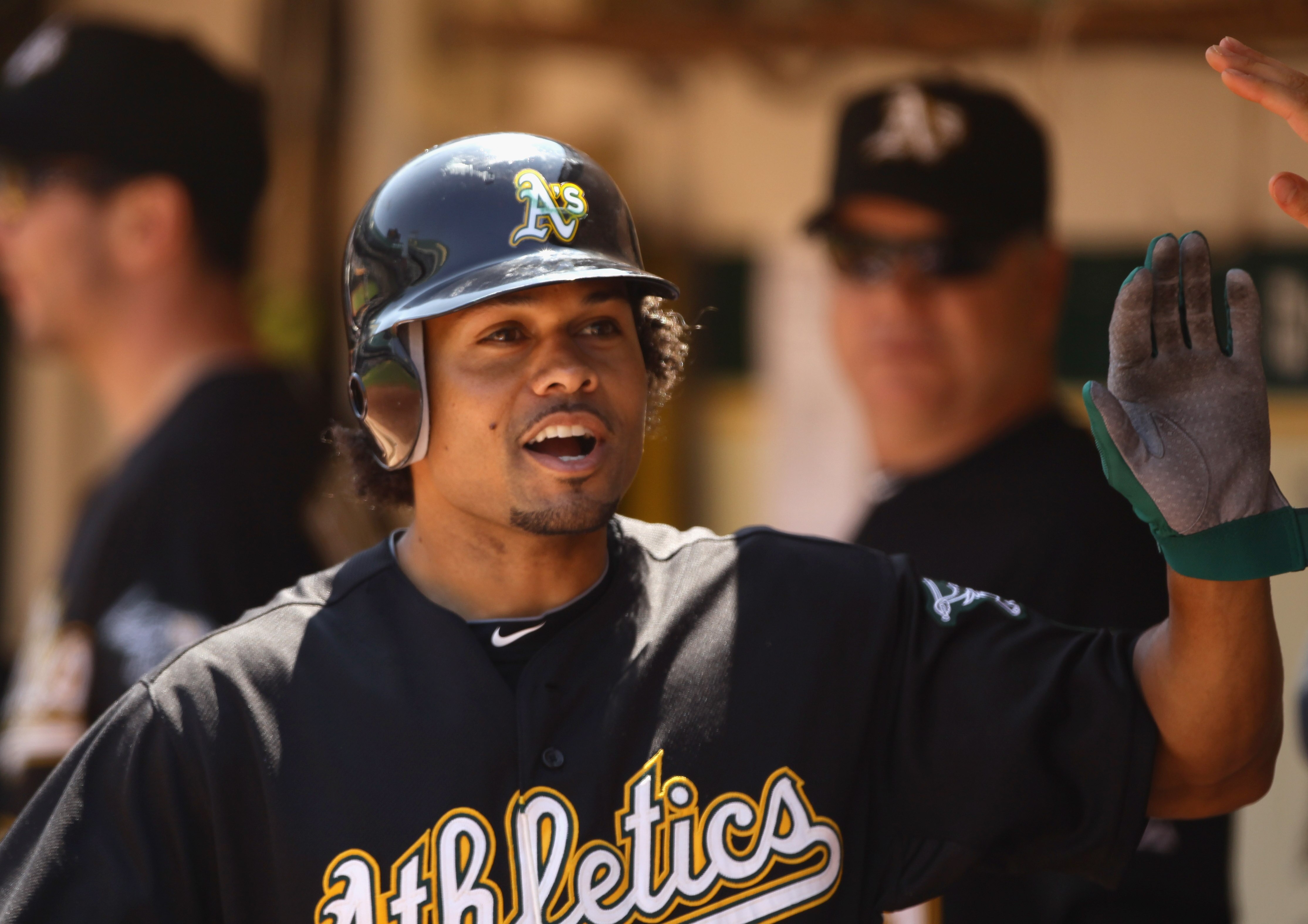 OAKLAND, CA - AUGUST 07:  Coco Crisp #4 of the Oakland Athletics is congratulated by teammates after he hit a home run in the second inning to give the Athletics a 3-0 lead over the Texas Rangers at the Oakland-Alameda County Coliseum on August 7, 2010 in