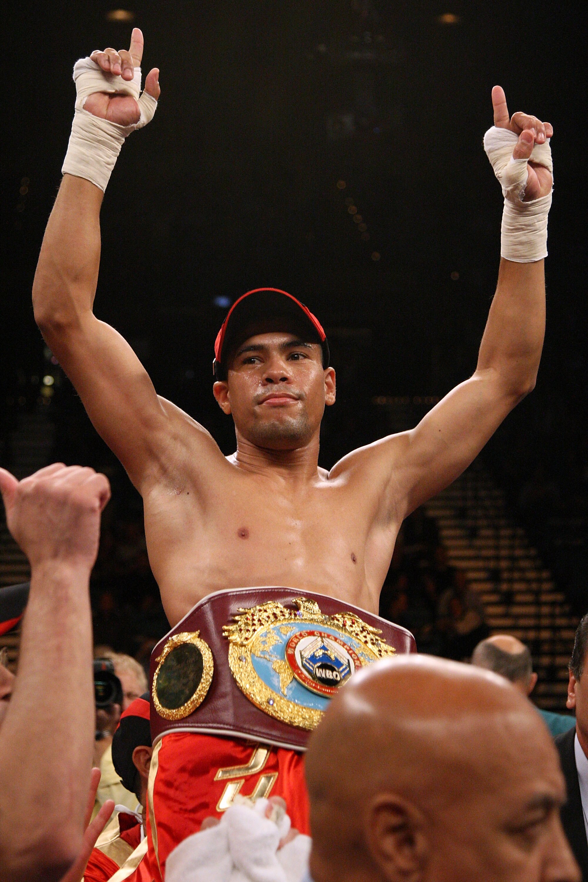 LAS VEGAS - DECEMBER 06:  (L-R) Juan Manuel Lopez of Puerto Rico celebrates his first round knockout of Sergio Medina of Argentina during their WBO junior featherweight title fight at the MGM Grand Garden Arena December 6, 2008 in Las Vegas, Nevada.  (Pho