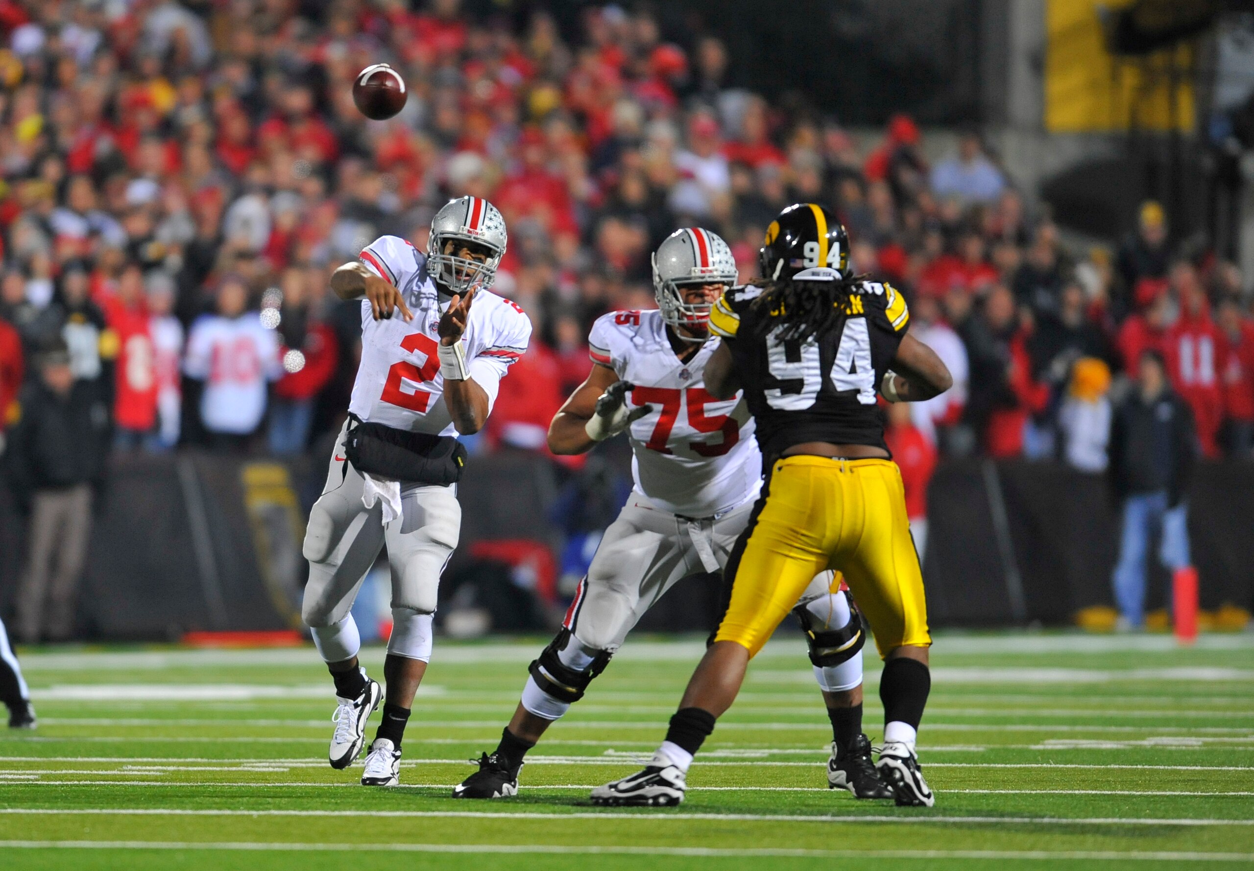 IOWA CITY, IA - NOVEMBER 20:  Quarterback Terrelle Pryor #2 of the Ohio State Buckeyes throws under pressure from defensive end Adrian Clayborn #94 of the University of Iowa Hawkeyes as offensive lineman Mike Adams #75 defends during the second half of pl