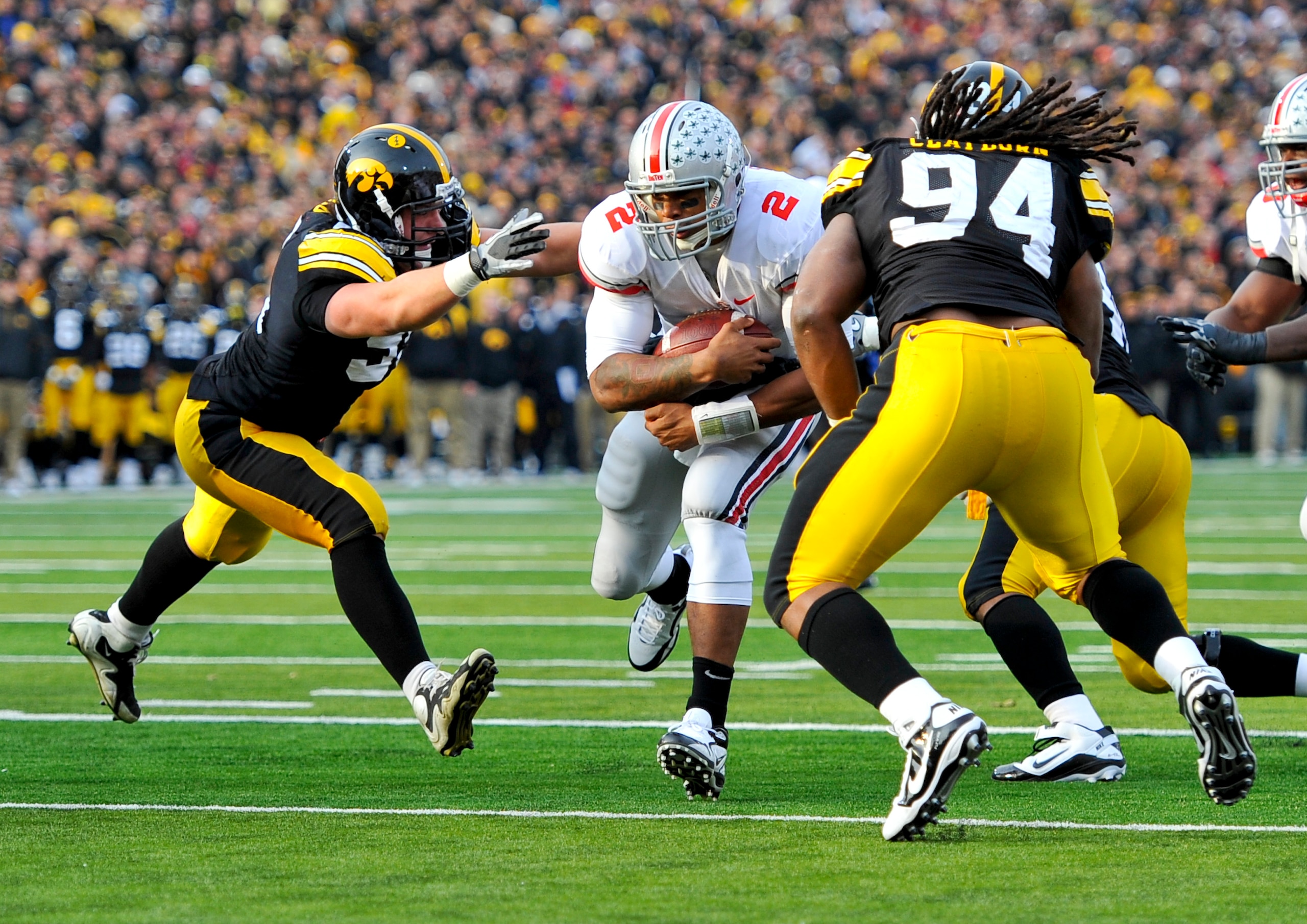 IOWA CITY, IA - NOVEMBER 20: Defeisive linemen Karl Klug #95 and Adrian Clayborn #94 of the University of Iowa Hawkeyes close in for the tackle on quarterback Terrelle Pryor #2 of the Ohio State Buckeyes as he drive the ball towards the goal line during t