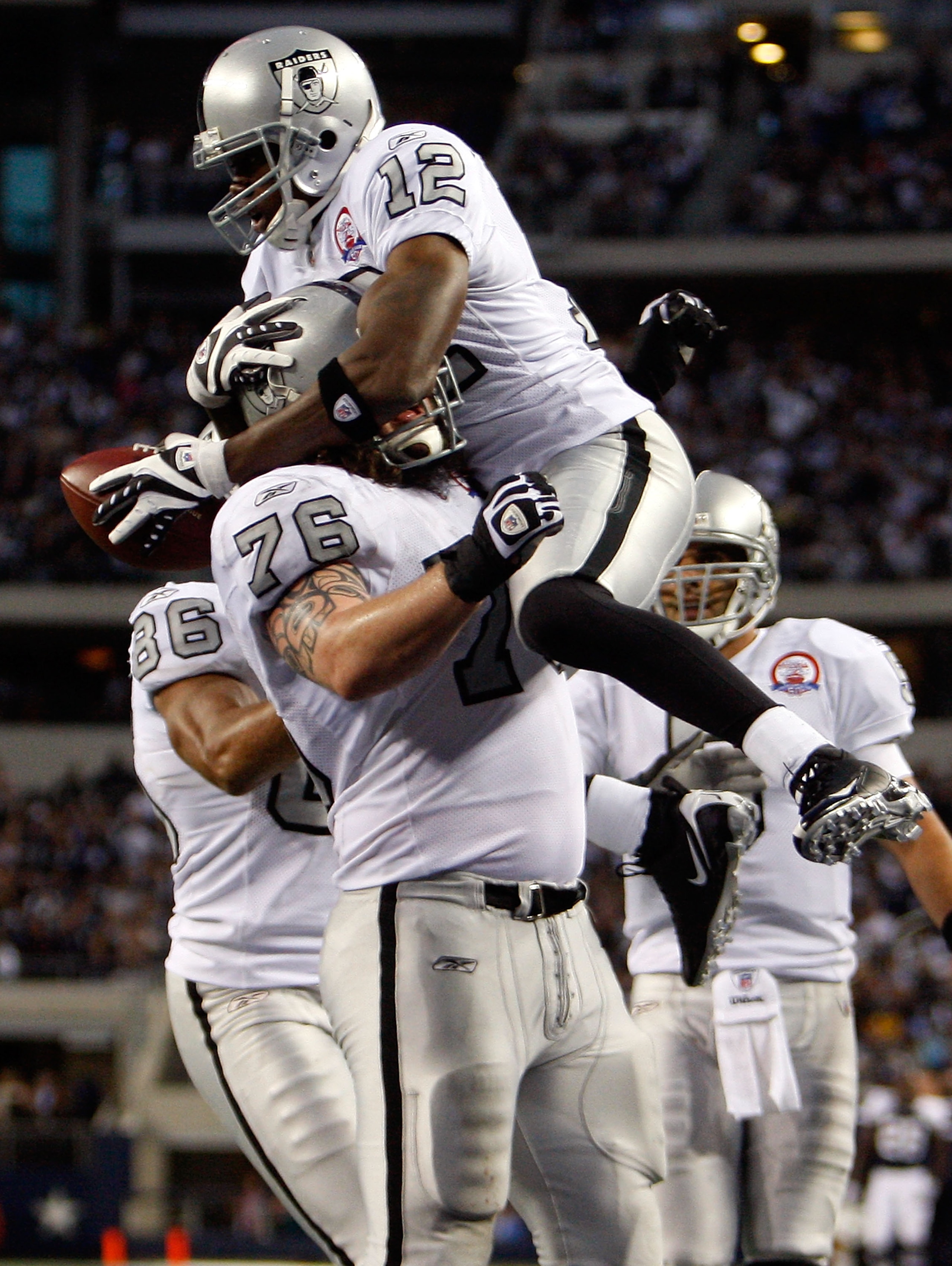 ARLINGTON, TX - NOVEMBER 26:  Wide receiver Darrius Heyward-Bey #12 of the Oakland Raiders celebrates a touchdown with Robert Gallery #76 against the Dallas Cowboys at Cowboys Stadium on November 26, 2009 in Arlington, Texas.  (Photo by Ronald Martinez/Ge