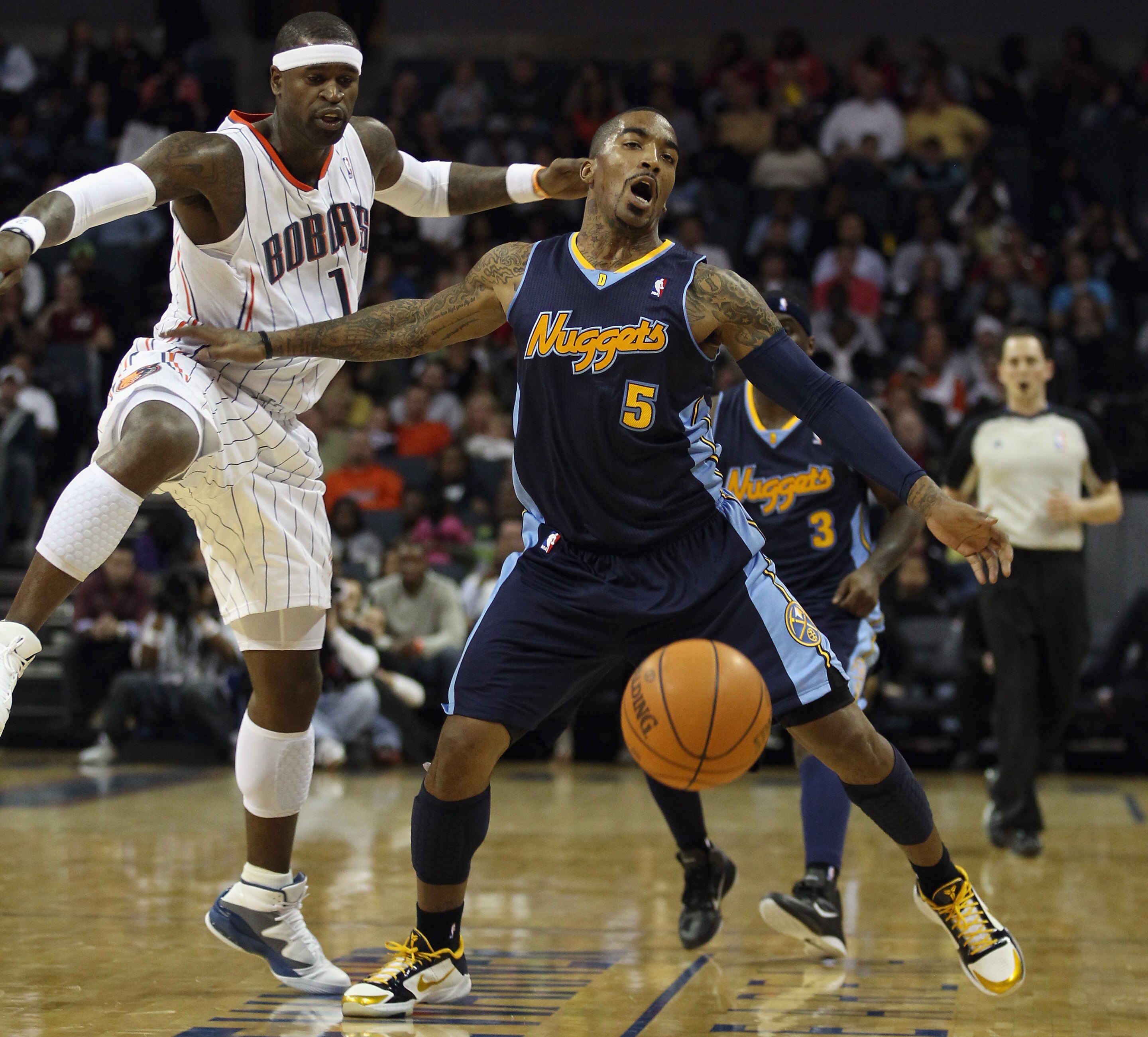 CHARLOTTE, NC - DECEMBER 07:  J.R. Smith #5 of the Denver Nuggets collides with Stephen Jackson #1 of the Charlotte Bobcats during their game at Time Warner Cable Arena on December 7, 2010 in Charlotte, North Carolina.  NOTE TO USER: User expressly acknow