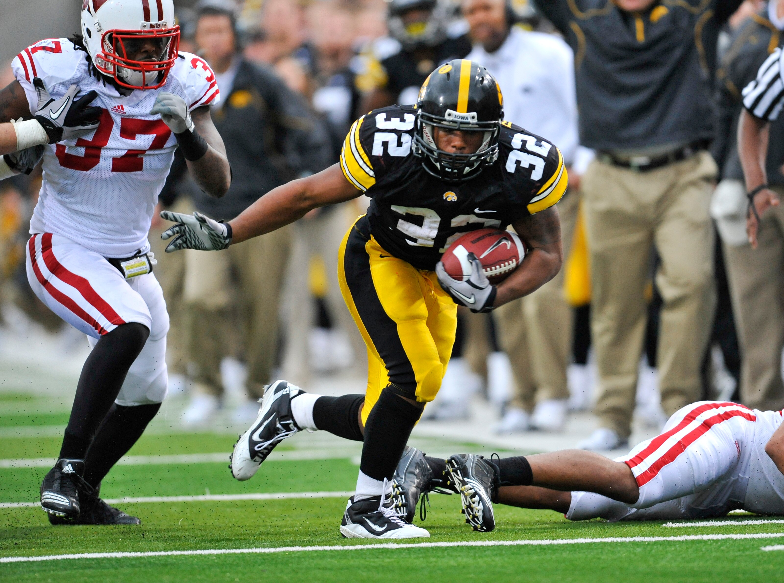 IOWA CITY, IA - OCTOBER 23- Linebacker Kevin Claxton #37 of the Wisconsin Badgers puts pressure on running back Adam Robinson #32 of the University of Iowa Hawkeyes as he rushes for yards during the second half of play at Kinnick Stadium on October 23, 20