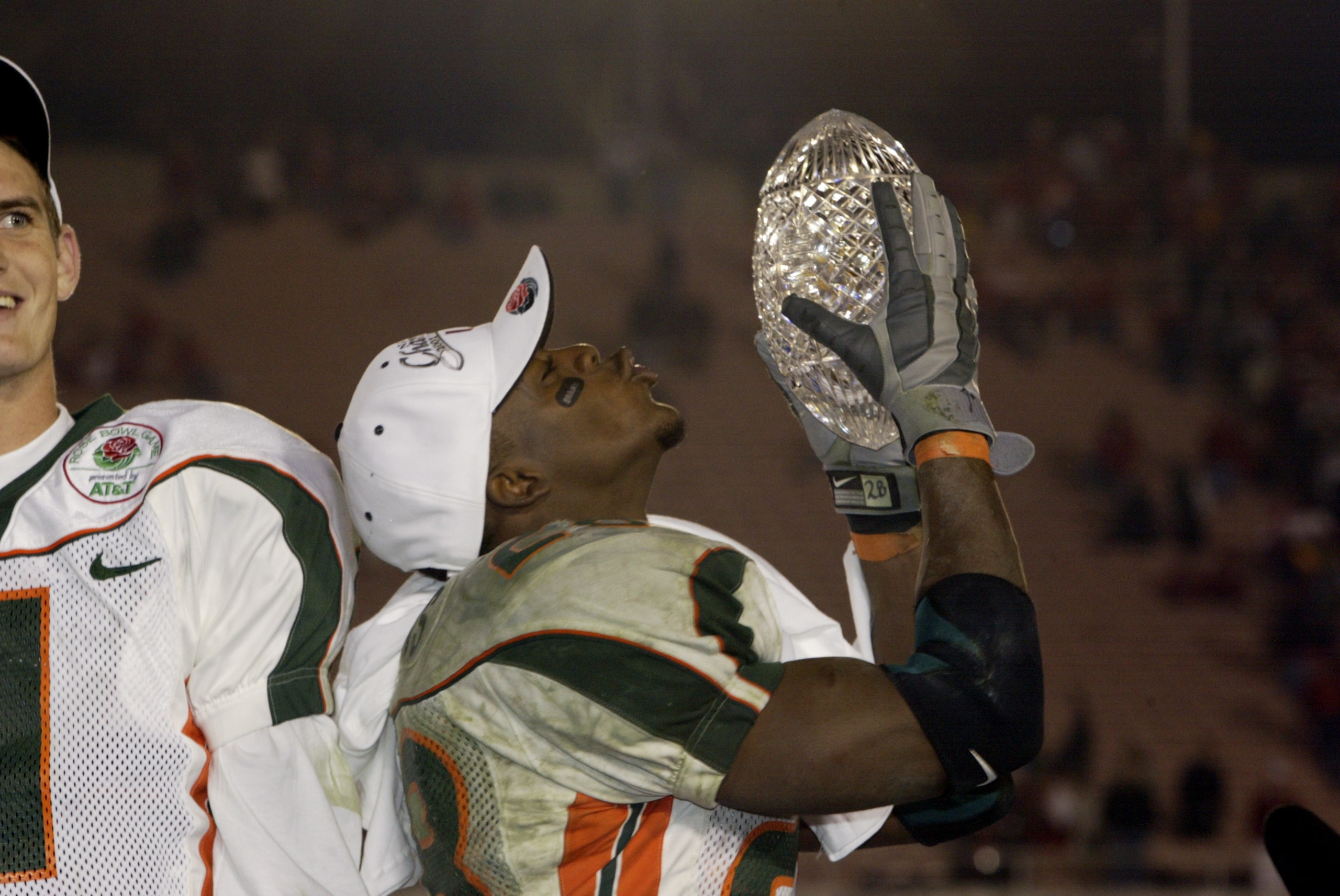 3 Jan 2002:  Clinton Portis #28 of Miami lifts the Sears National Championship trophy as quarterback Ken Dorsey #11 looks on after the win over Nebraska in the Rose Bowl National Championship game at the Rose Bowl in Pasadena, California.  Miami won the g