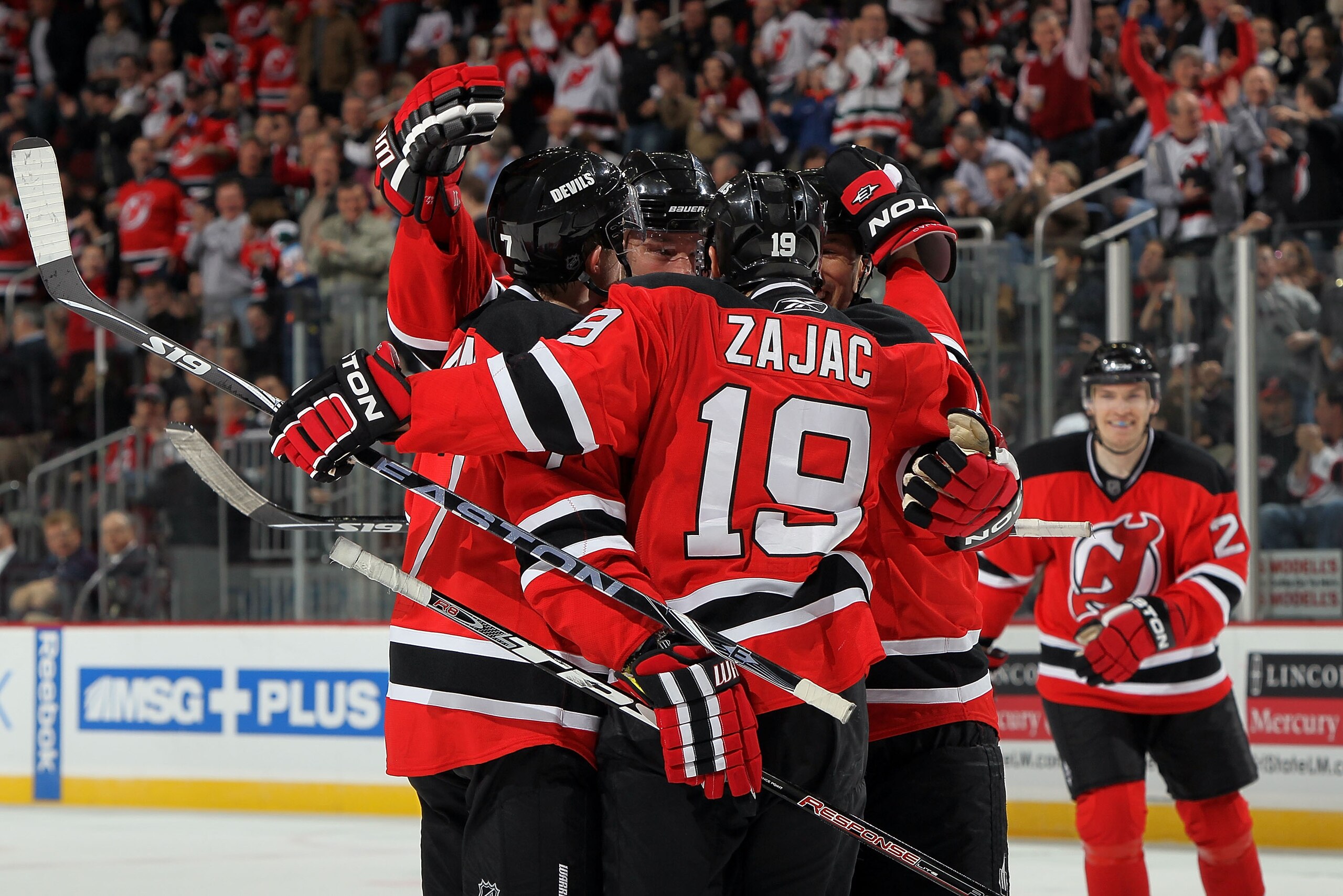 NEWARK, NJ - MARCH 23:  Travis Zajac #19 of the New Jersey Devils celebrates his first goal against the Columbus Blue Jackets with his teammates at the Prudential Center on March 23, 2010 in Newark, New Jersey.  (Photo by Jim McIsaac/Getty Images)