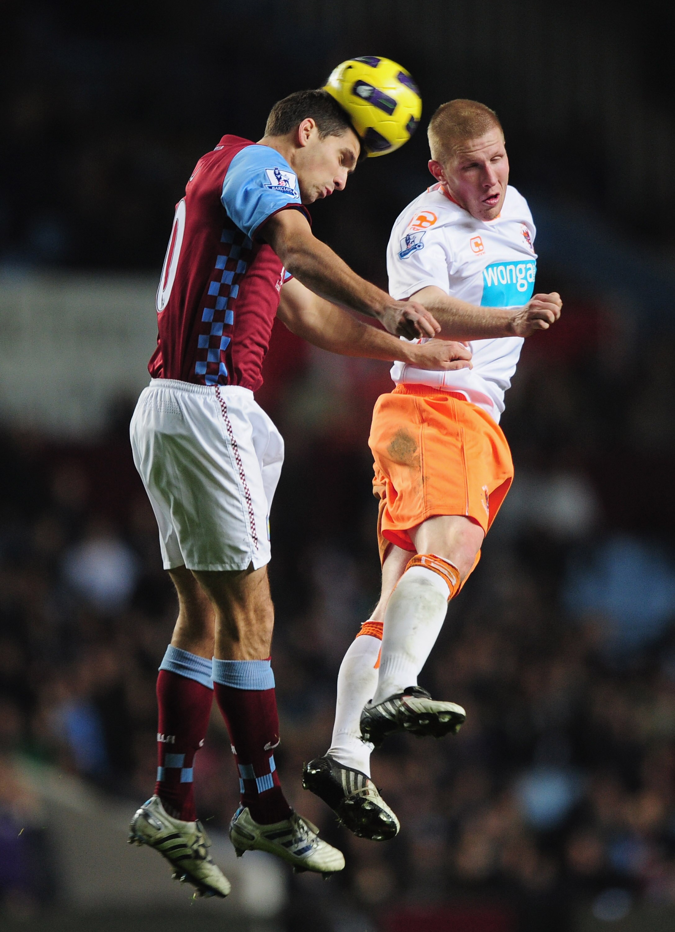 BIRMINGHAM, ENGLAND - NOVEMBER 10:  Keith Southern of Blackpool and Eric Lichaj of Aston Villa challenge for the ball during the Barclays Premier League match between Aston Villa and Blackpool at Villa Park on November 10, 2010 in Birmingham, England.  (P