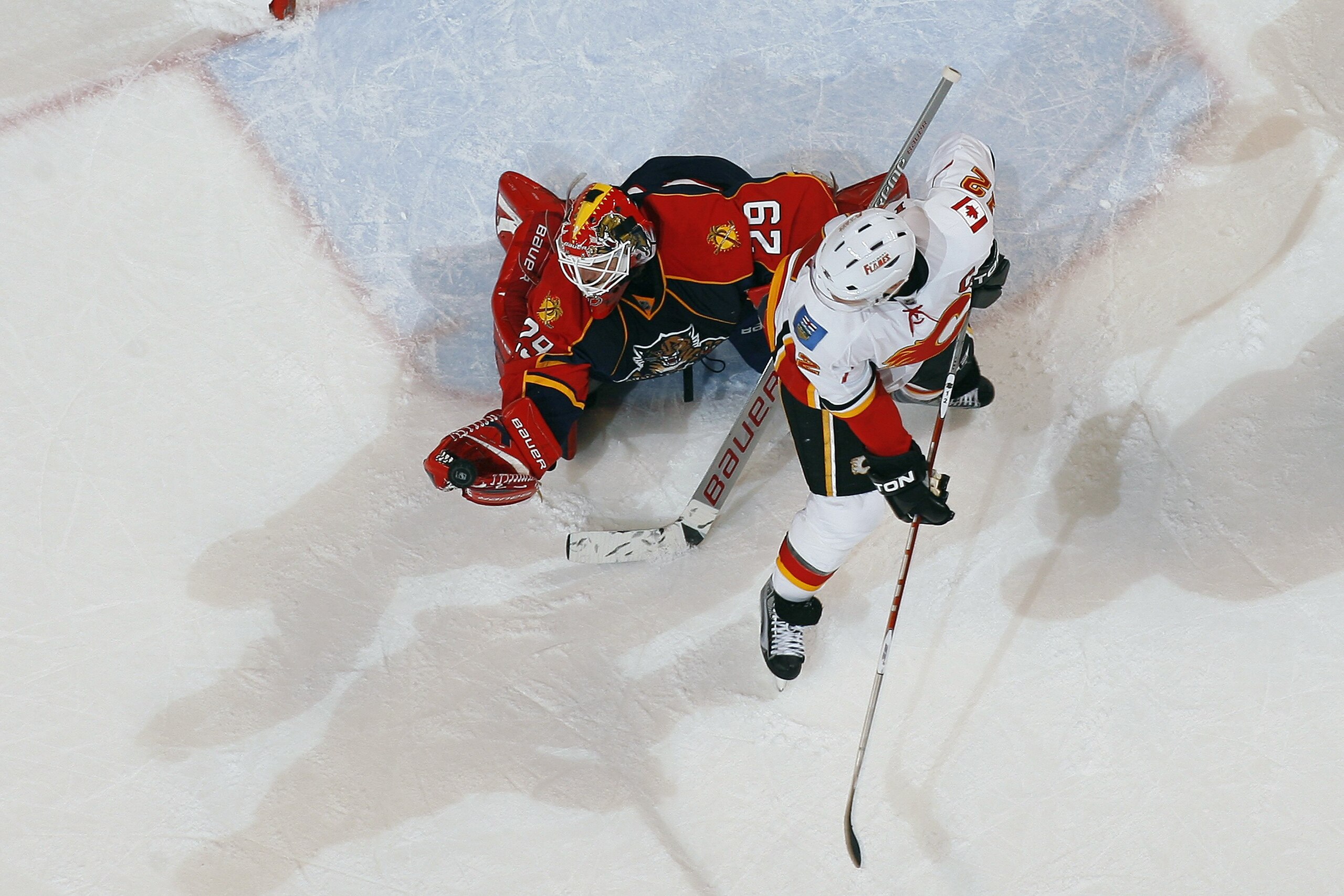 SUNRISE, FL - FEBRUARY 5: Jarome Iginla #12 of the Calgary Flames looks back to see goaltender Tomas Vokoun #29 of the Florida Panthers make a glove save on February 5, 2010 at the BankAtlantic Center in Sunrise, Florida. The Flames defeated the Panthers