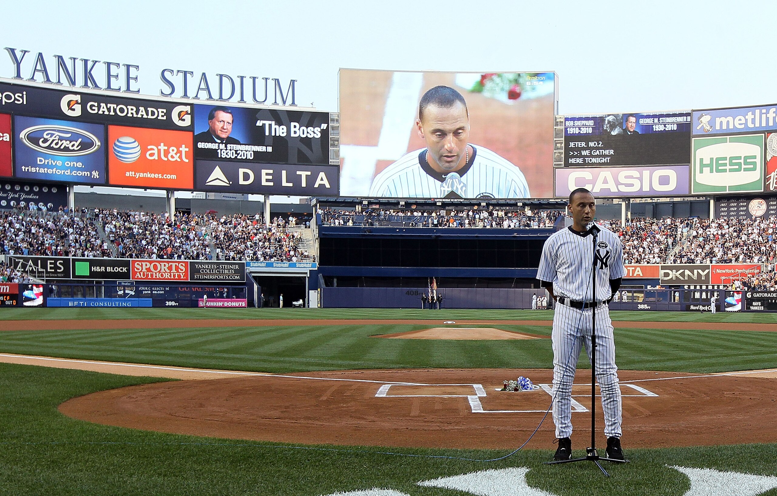 NEW YORK - JULY 16:  Captain Derek Jeter #2 of the New York Yankees speaks during the ceremony for owner George Steinbrenner and Yankee Stadium public address announcer Bob Sheppard before the game against theTampa Bay Rays on July 16, 2010 in the Bronx b