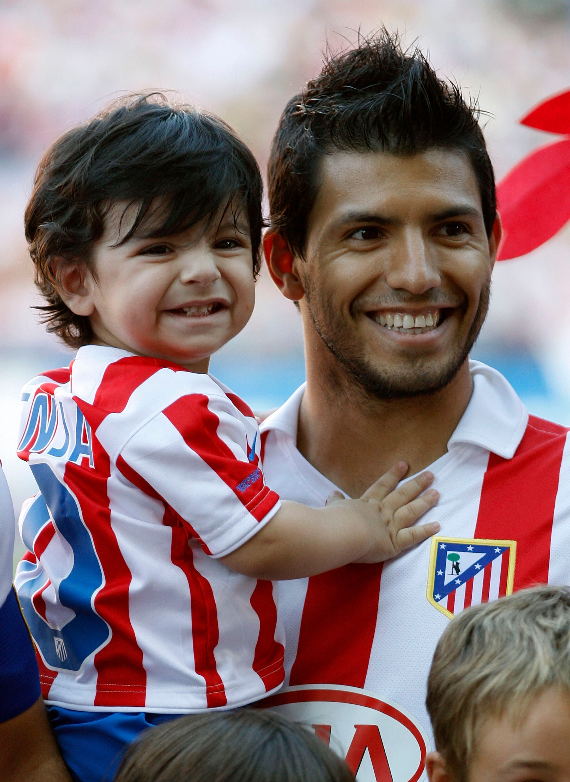 MADRID, SPAIN - SEPTEMBER 19: Sergio Aguero of Atletico smiles with his son Benjamin during the La Liga match between Atletico Madrid and Barcelona at Vicente Calderon Stadium on September 19, 2010 in Madrid, Spain. (Photo by Angel Martinez/Getty Images)