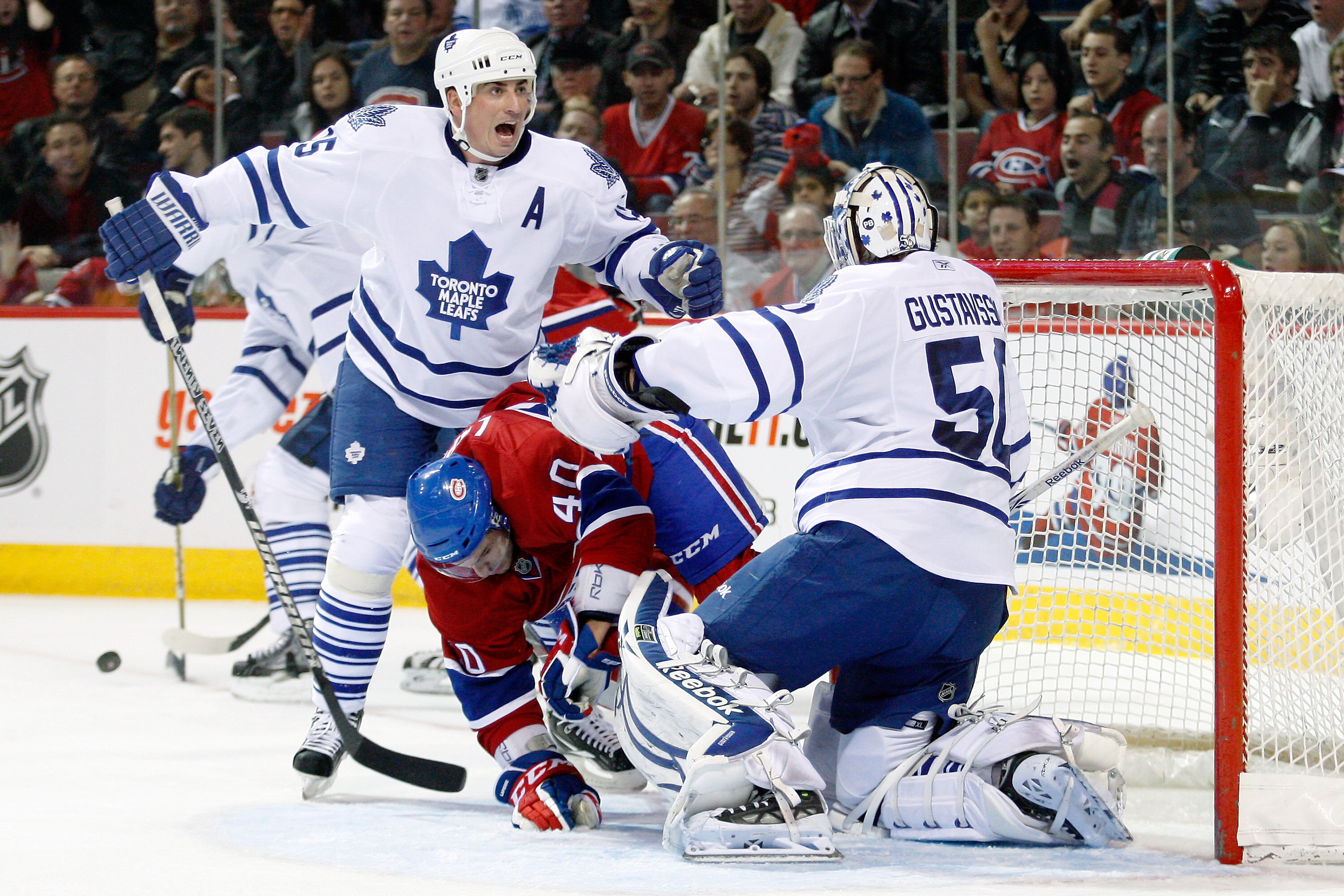 MONTREAL - NOVEMBER 20:  Tomas Kaberle #15 of the Toronto Maple Leafs reacts to Maxim Lapierre #40 of the Montreal Canadiens running into teammate Jonas Gustavsson #50 during the NHL game at the Bell Centre on November 20, 2010 in Montreal, Quebec, Canada