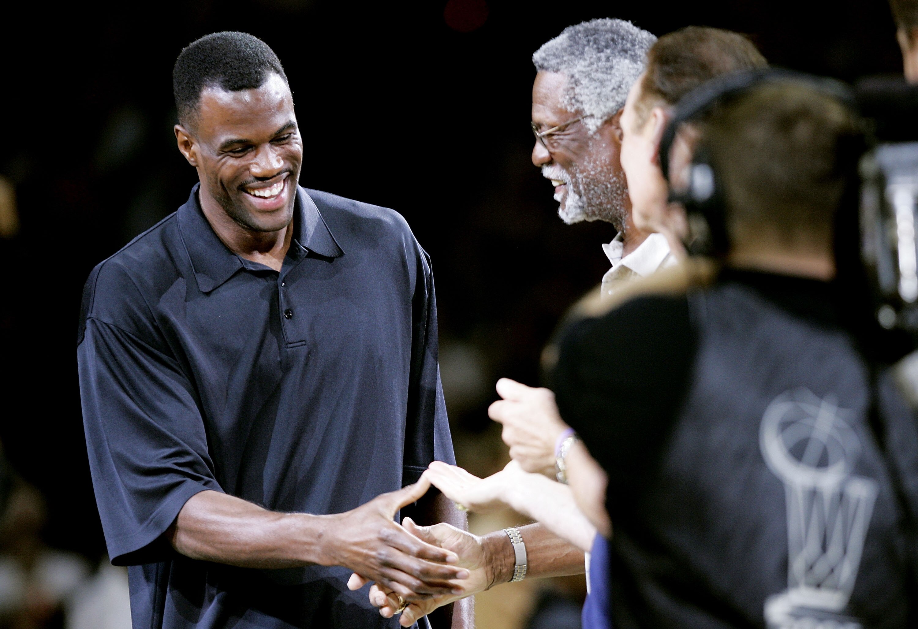 SAN ANTONIO - JUNE 12:  Former Spur David Robinson, L, shakes the hand of NBA legend Bill Russell as the two are honored during a half-time ceremony as the San Antonio Spurs take on the Detroit Pistons in Game two of the 2005 NBA Finals on June 12, 2005 a