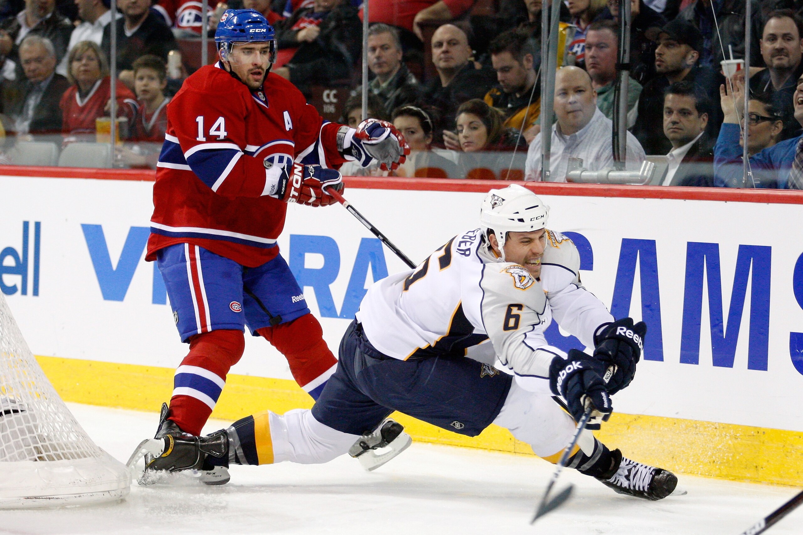 MONTREAL - NOVEMBER 18:  Shea Weber #6 of the Nashville Predators clears the puck while being chased by Tomas Plekanec #14 of the Montreal Canadiens during the NHL game at the Bell Centre on November 18, 2010 in Montreal, Quebec, Canada.  (Photo by Richar