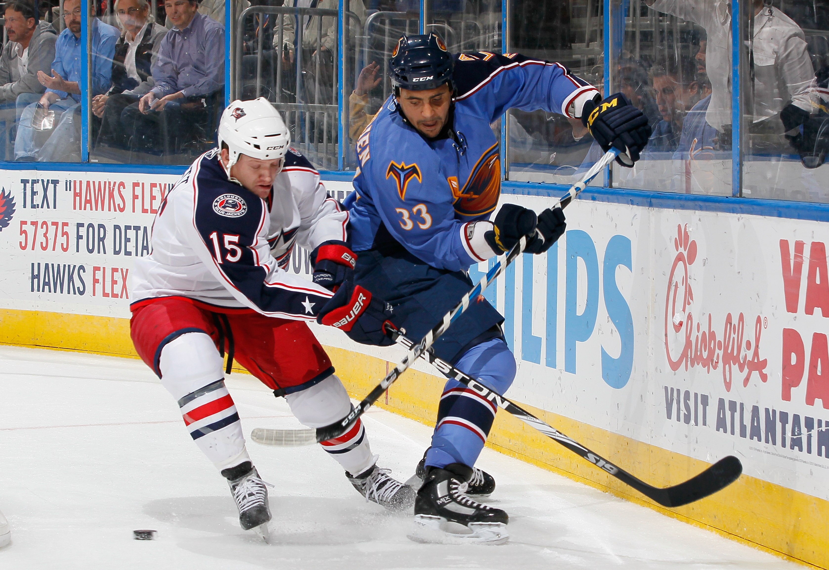 ATLANTA - NOVEMBER 04:  Derek Dorsett #15 of the Columbus Blue Jackets battles for the puck against Dustin Byfuglien #33 of the Atlanta Thrashers at Philips Arena on November 4, 2010 in Atlanta, Georgia.  (Photo by Kevin C. Cox/Getty Images)