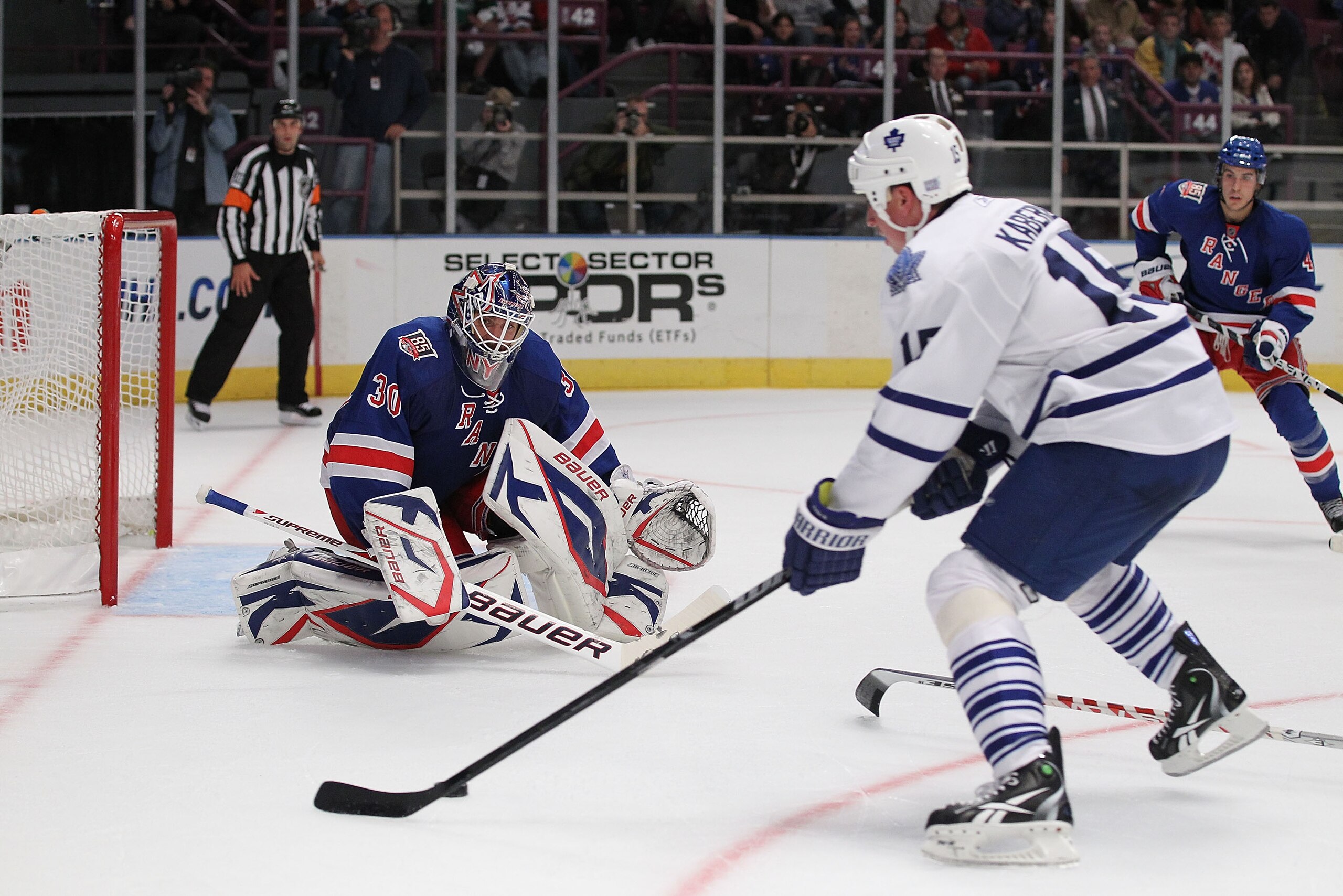 NEW YORK - OCTOBER 15: Henrik Lundqvist #30 of the New York Rangers defends a shot by Tomas Kaberle #15 of the Toronto Maple Leafs during their game on October 15, 2010 at Madison Square Garden in New York City. (Photo by Al Bello/Getty Images) NEW YORK - OCTOBER 15: Henrik Lundqvist #30 of the New York Rangers defends a shot by Tomas Kaberle #15 of the Toronto Maple Leafs during their game on October 15, 2010 at Madison Square Garden in New York City. (Photo by Al Bello/Getty Images)