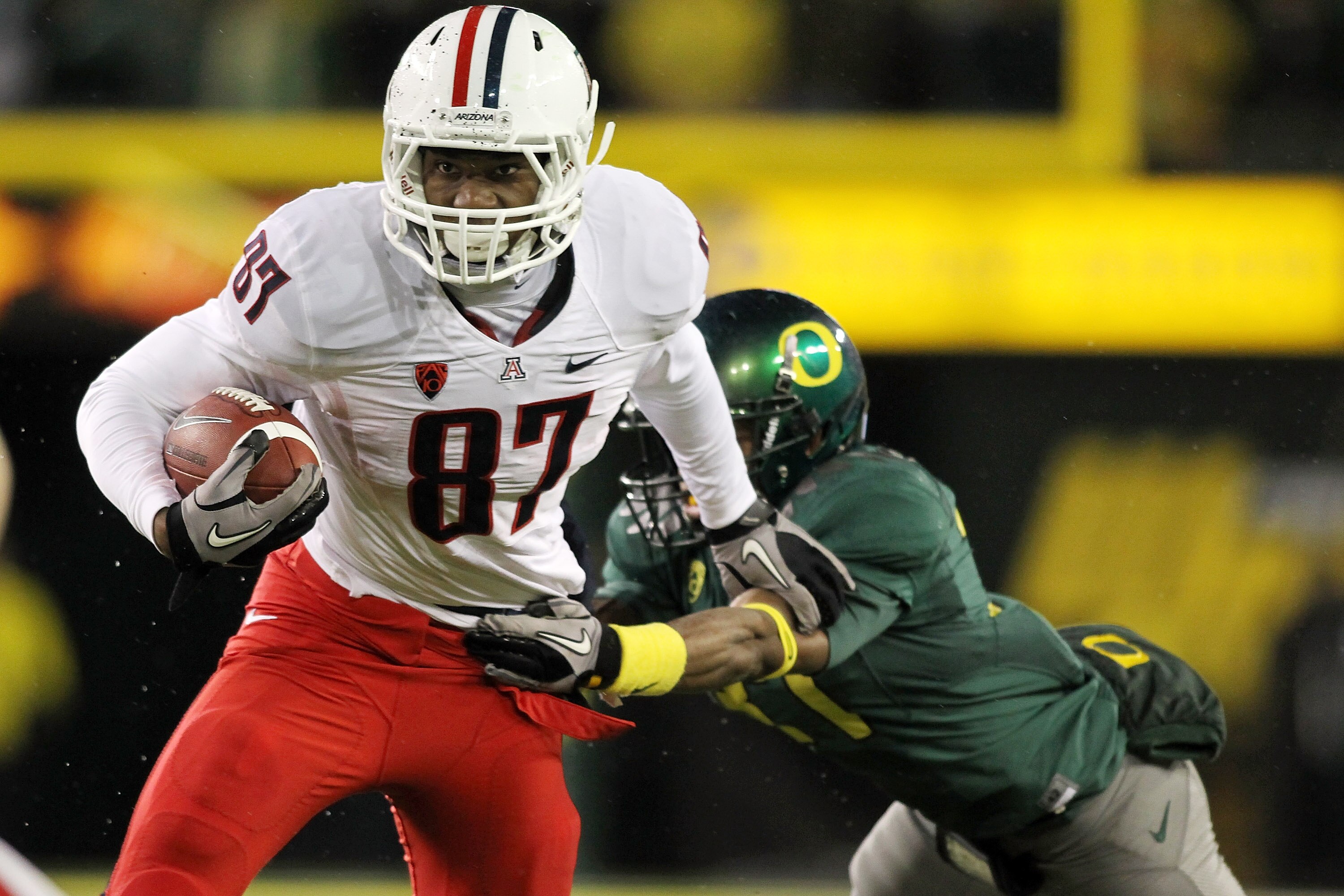 EUGENE, OR - NOVEMBER 26:  Terrence Miller #87 of the Arizona Wildcats runs with the ball  against the Oregon Ducks  on November 26, 2010 at the Autzen Stadium in Eugene, Oregon.  (Photo by Jonathan Ferrey/Getty Images)