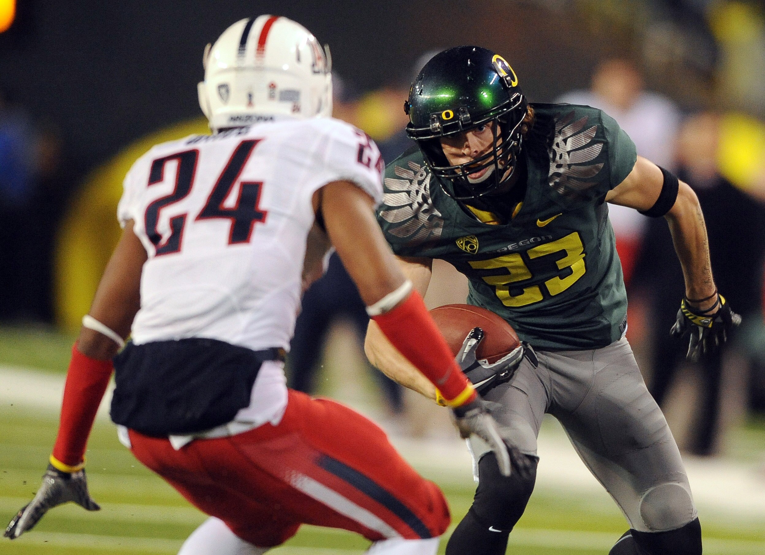 EUGENE, OR - NOVEMBER 26: Wide receiver Jeff Maehl #23 of the Oregon Ducks puts a move on cornerback Trevin Wade #24 of the Arizona Wildcats in the fourth quarter of the game at Autzen Stadium on November 26, 2010 in Eugene, Oregon. The Ducks won the game