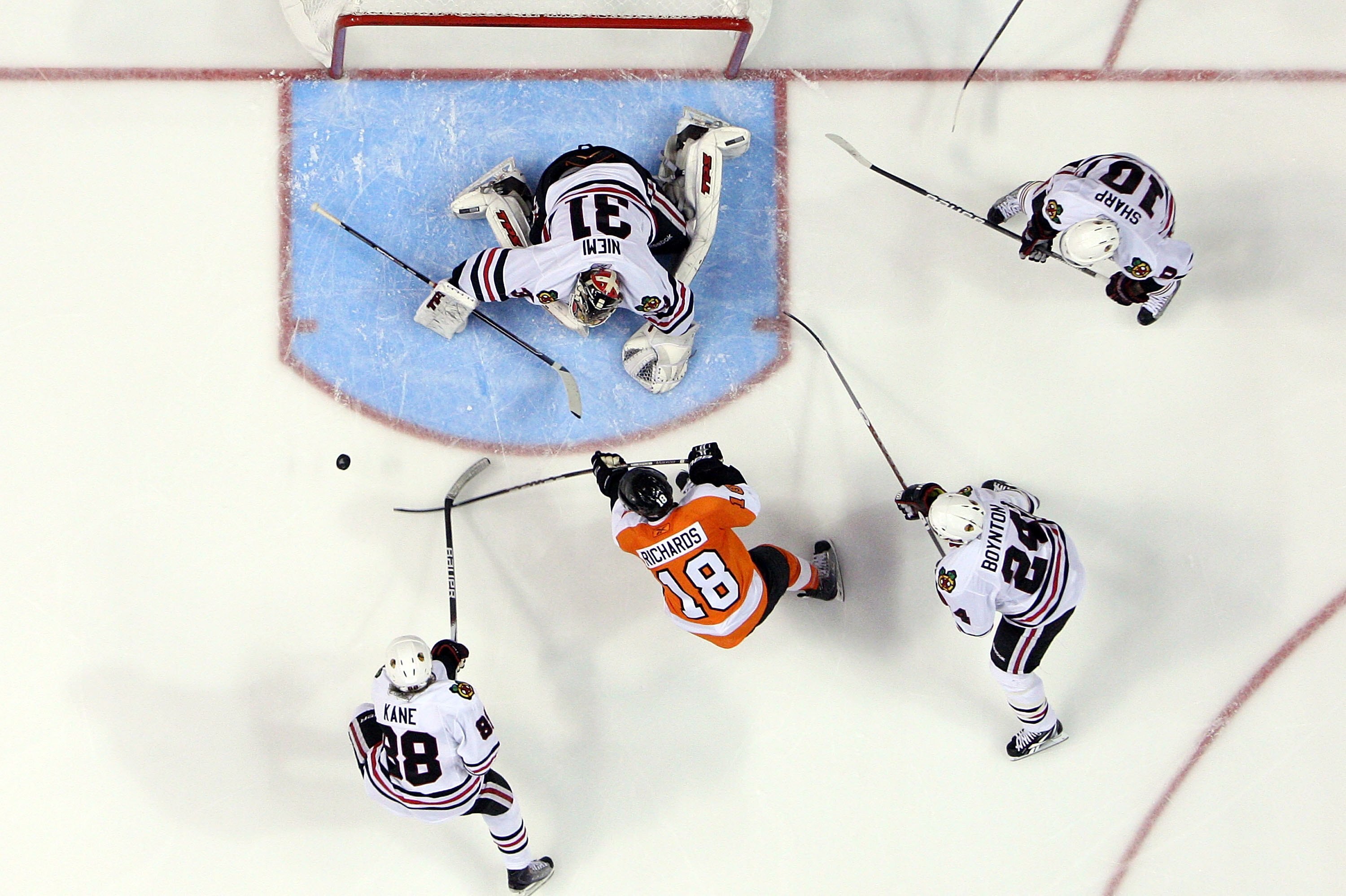 PHILADELPHIA - JUNE 09:  Antti Niemi #31, Patrick Kane #88, Patrick Sharp #10, and Nick Boynton #24 of the Chicago Blackhawks combine to stop a scoring chance from Mike Richards #18 of the Philadelphia Flyers in Game Six of the 2010 NHL Stanley Cup Final