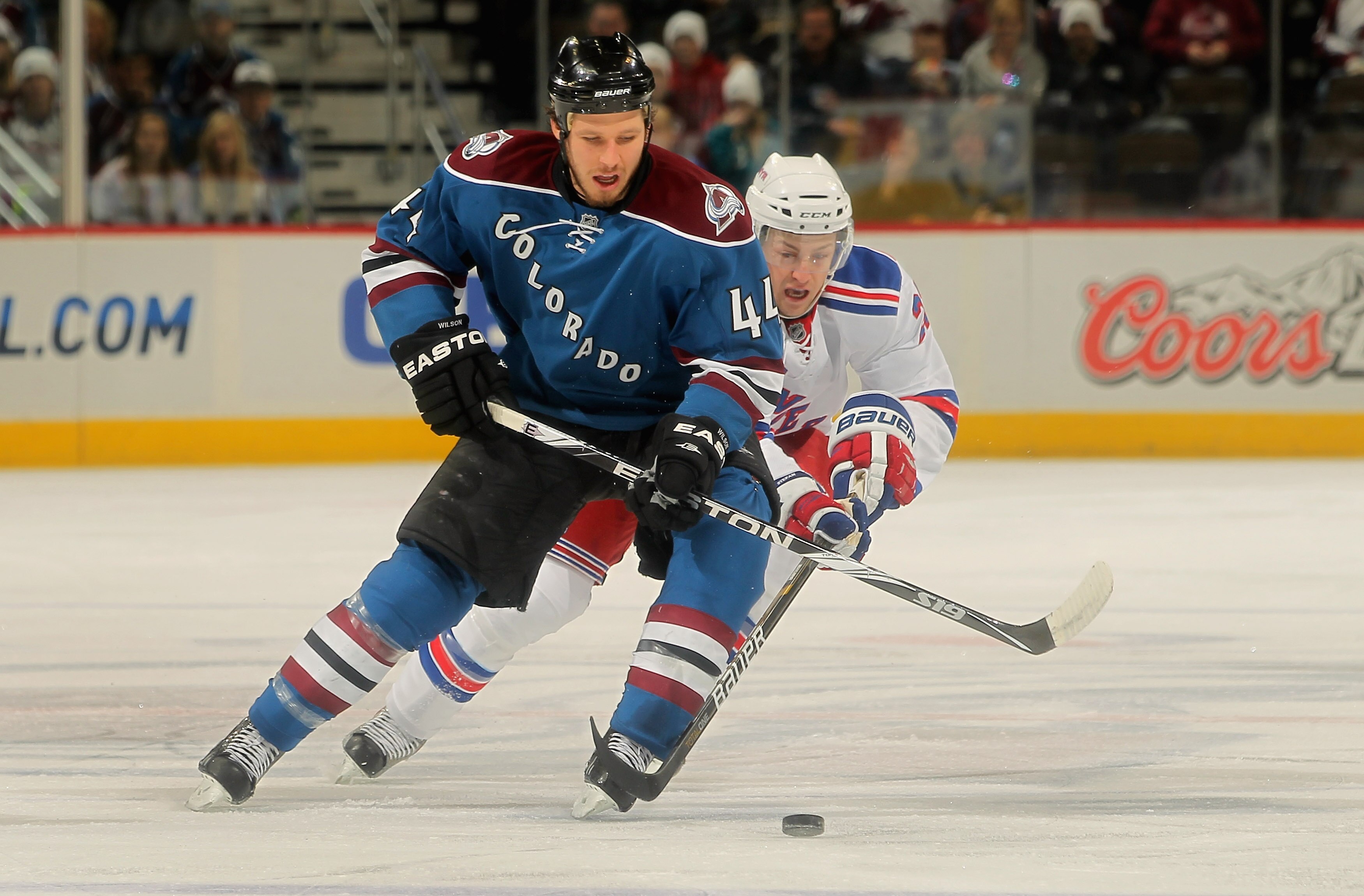 DENVER - NOVEMBER 19:  Ryan Wilson #44 of the Colorado Avalanche tries to control the puck while under pressure from Derek Stepan #21 of the New York Rangers at the Pepsi Center on November 19, 2010 in Denver, Colorado.  (Photo by Doug Pensinger/Getty Ima