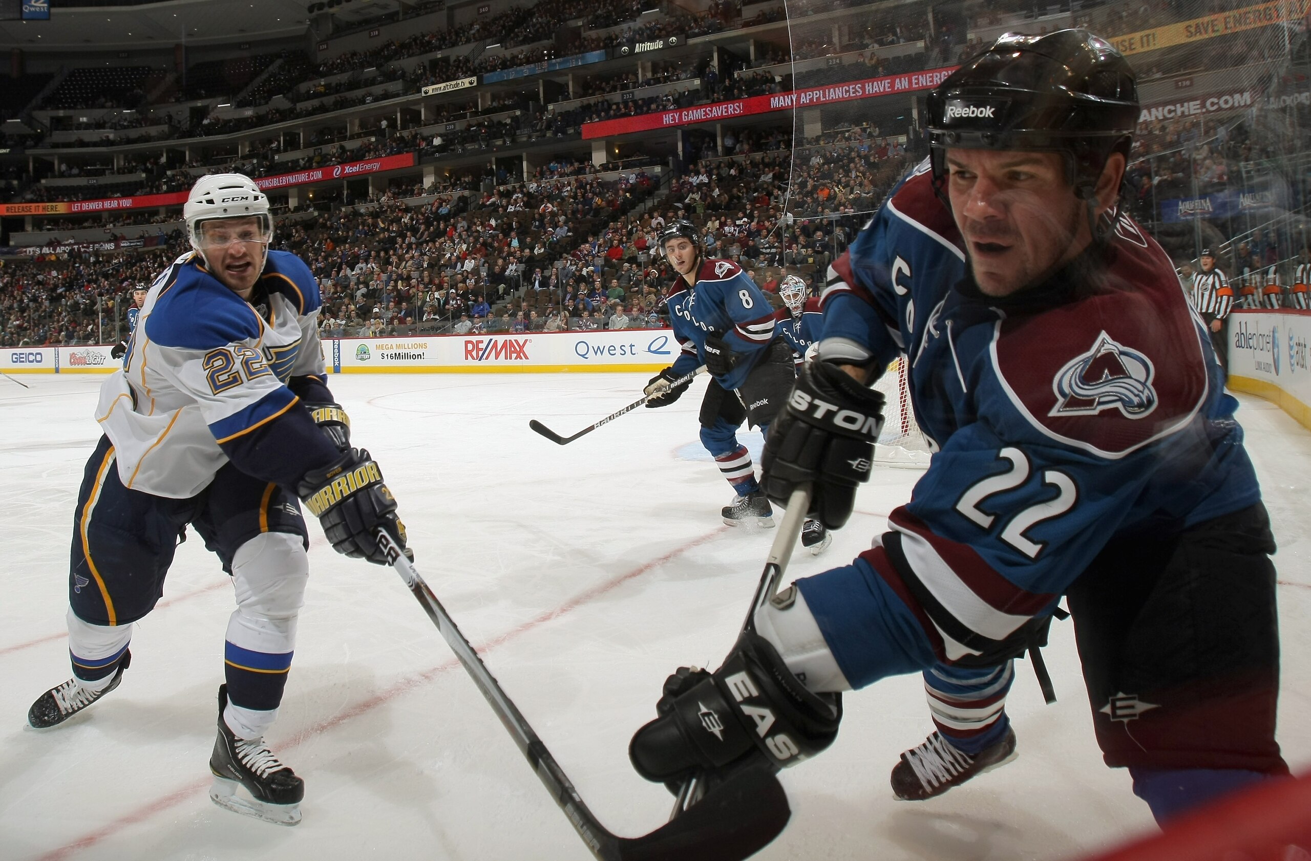 DENVER - NOVEMBER 15:  Scott Hannan #22 of the Colorado Avalanche and Brad Boyes #22 of the St. Louis Blues battle for the puck at the Pepsi Center on November 15, 2010 in Denver, Colorado. The Avalanche defeated the Blues 6-3.  (Photo by Doug Pensinger/G