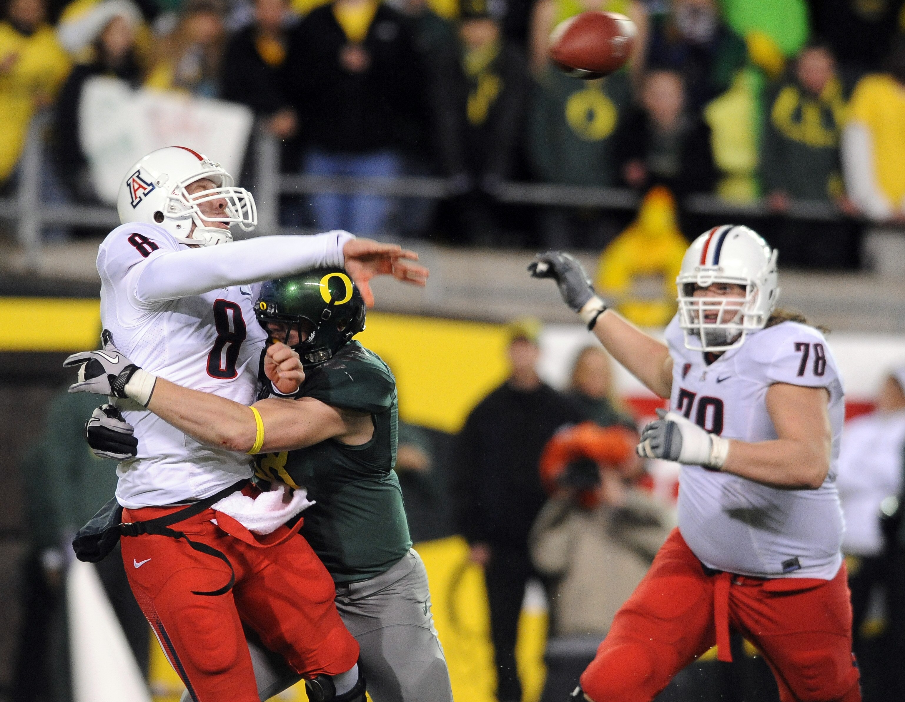 EUGENE, OR - NOVEMBER 26: Defensive end Brandon Bair #88 of the Oregon Ducks hits quarterback Nick Foles #8 of the Arizona Wildcats in the fourth quarter of the game at Autzen Stadium on November 26, 2010 in Eugene, Oregon.The Ducks won the game 48-29. (P