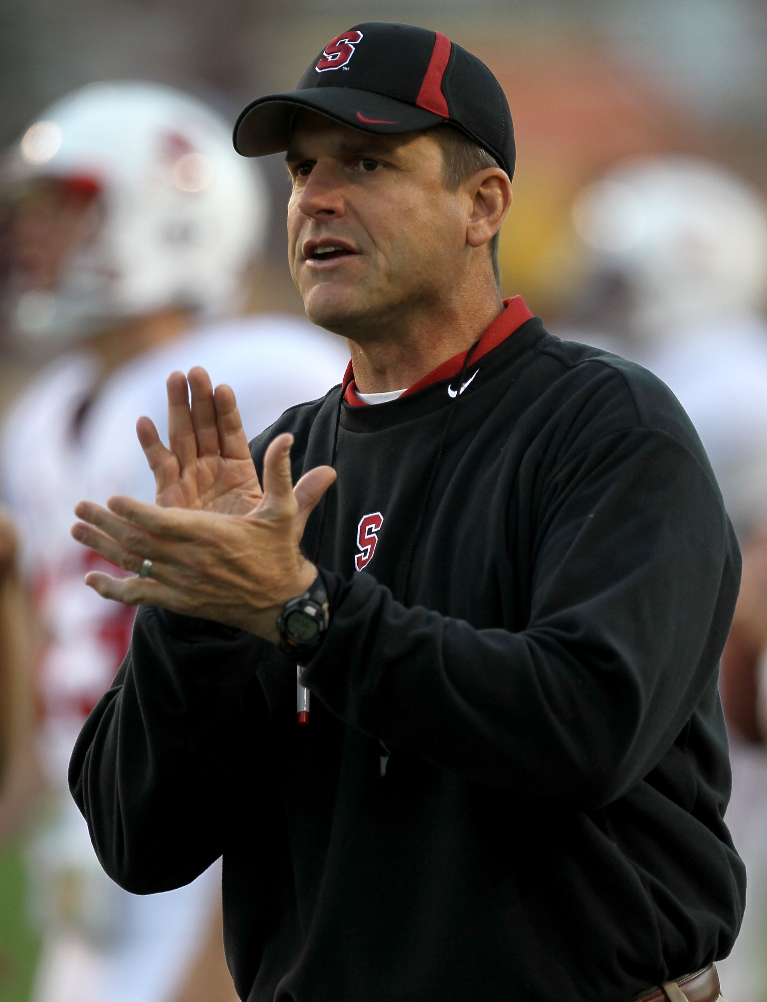 TEMPE, AZ - NOVEMBER 13:  Head coach Jim  Harbaugh of the Stanford Cardinal cheers his team on as they warm up for the game with the Arizona State Sun Devils  at Sun Devil Stadium on November 13, 2010 in Tempe, Arizona. (Photo by Stephen Dunn/Getty Images