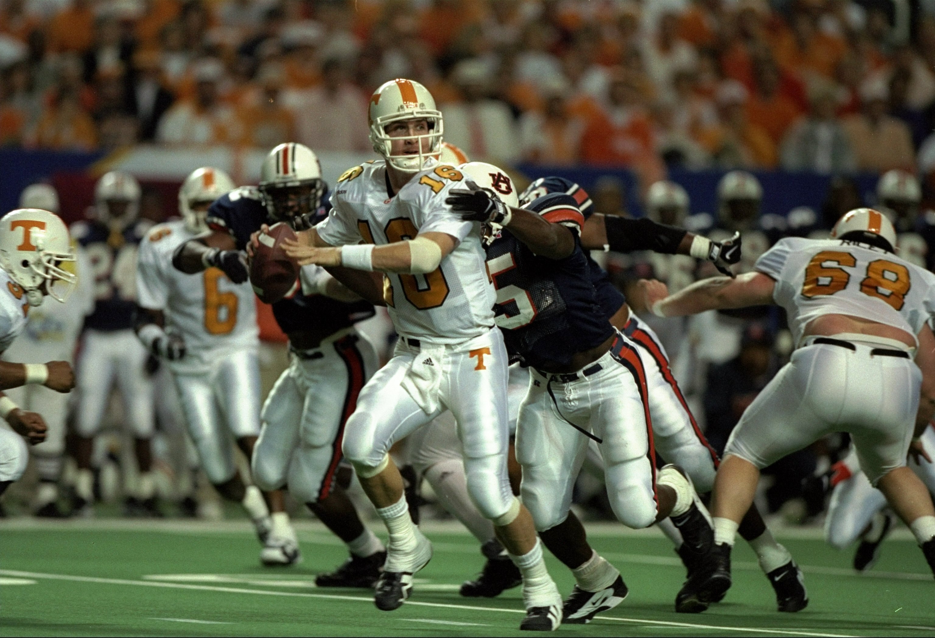 6 Dec 1997: Quarterback Peyton Manning #16 of Tennessee is hit by Leonardo Carson #95 of Auburn during the Volunteers 30-29 win over Auburn in the SEC Championship at the Georgia Dome in Atlanta, Georgia.