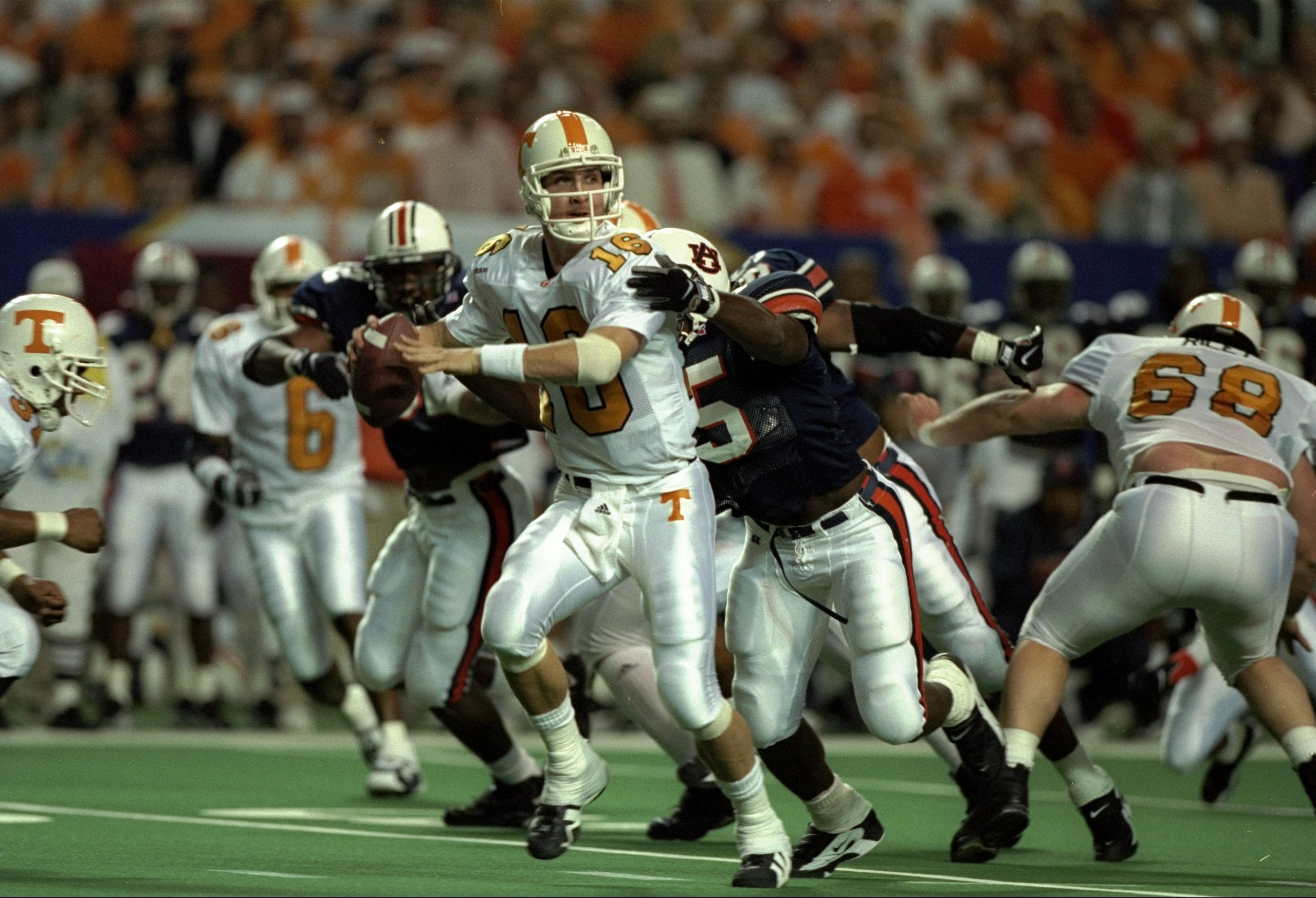 6 Dec 1997: Quarterback Peyton Manning #16 of Tennessee is hit by Leonardo Carson #95 of Auburn during the Volunteers 30-29 win over Auburn in the SEC Championship at the Georgia Dome in Atlanta, Georgia.