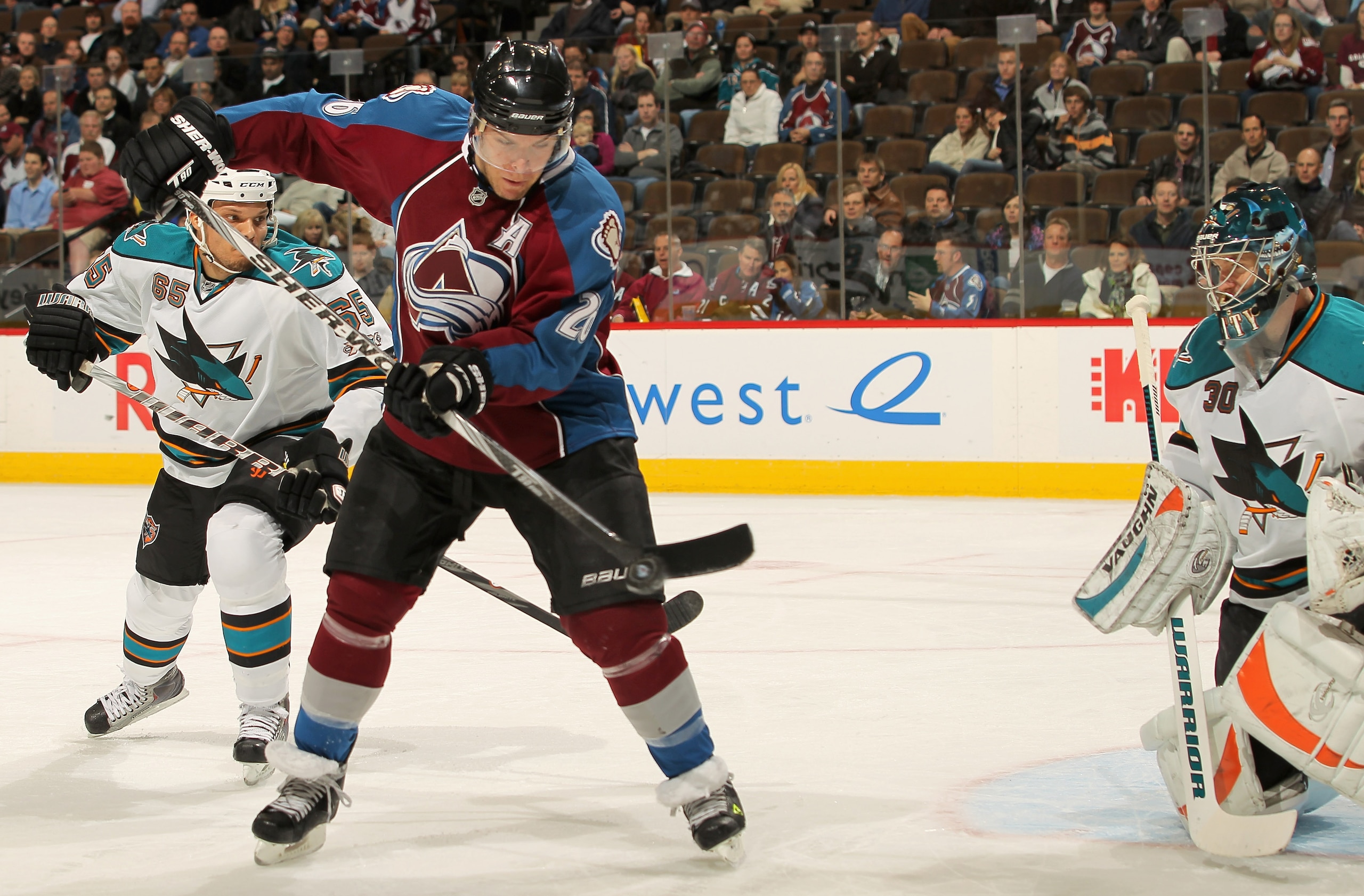 DENVER - NOVEMBER 17:  Paul Stastny #26 of the Colorado Avalanche tries to collect the puck while Goalie antero Niiittmaki #30 of the San Jose Sharks protects the goal and Derek Joslin #65 defends at the Pepsi Center on November 17, 2010 in Denver, Colora