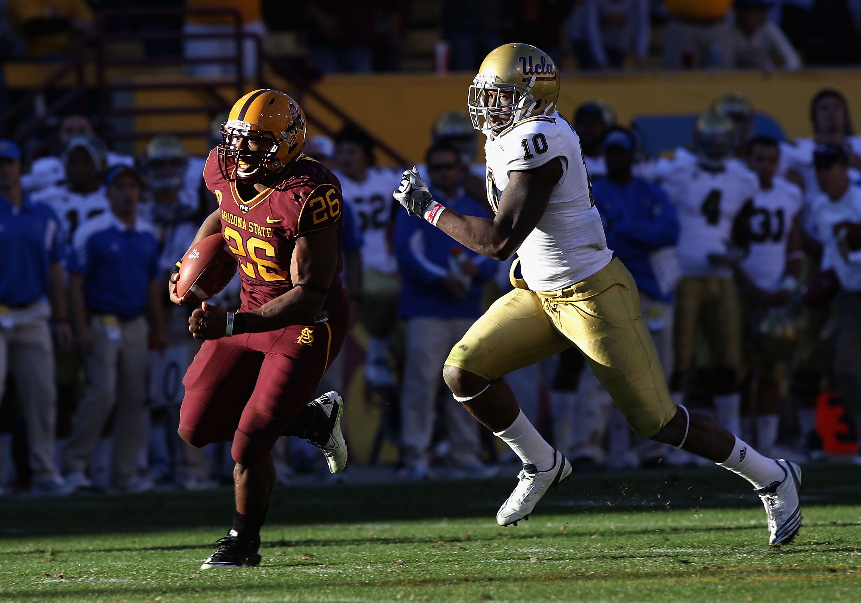 TEMPE, AZ - NOVEMBER 26:  Runningback Cameron Marshall #26 of the Arizona State Sun Devils carries the football for a 71 yard rushing touchdown past Ryan Sublett #10 of the UCLA Bruins during the thrid quarter of the college football game at Sun Devil Sta