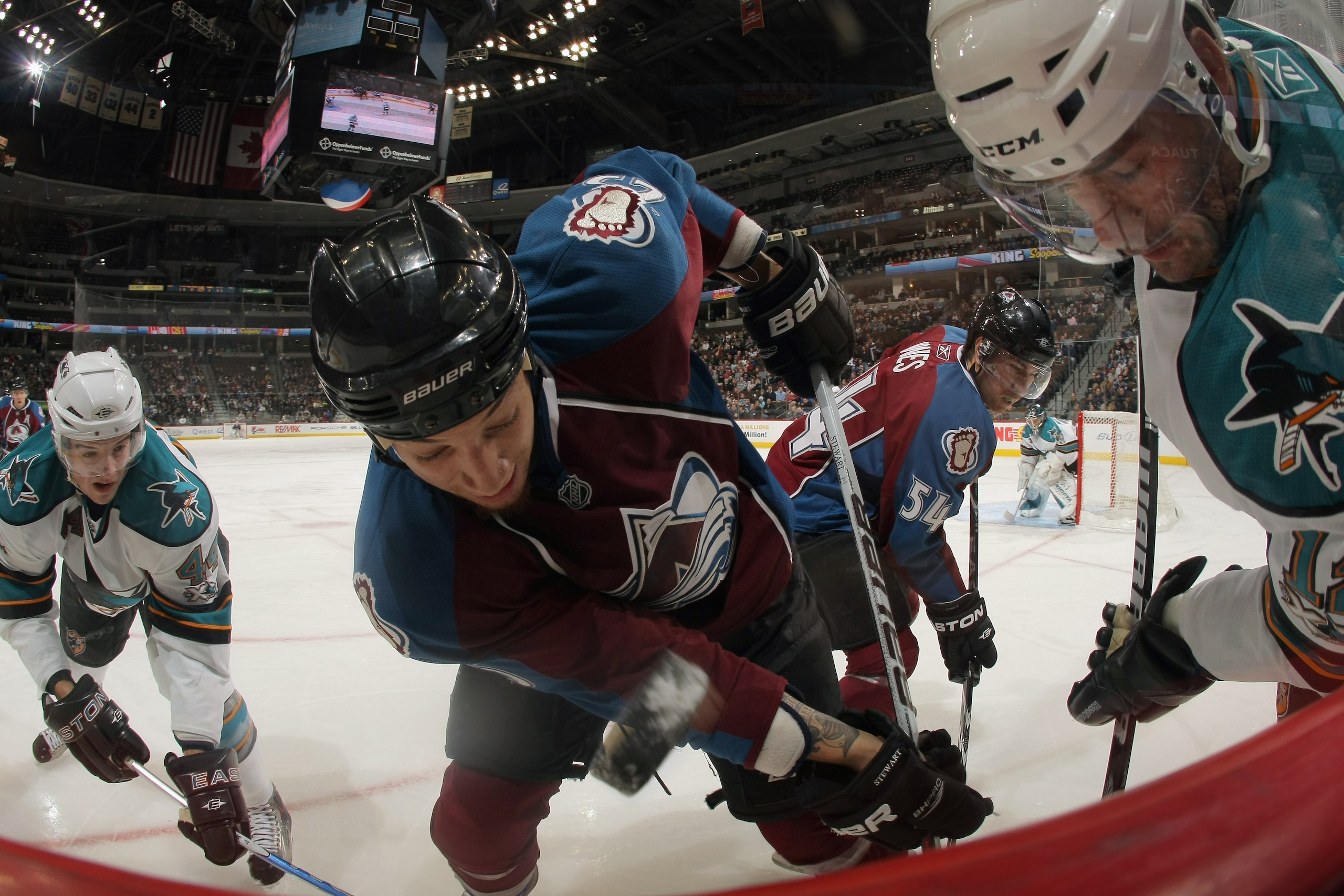 DENVER - NOVEMBER 17:  Chris Stewart #25 of the Colorado Avalanche battles for the puck between Marc-Edouad Vlasic #44 and Patrick Marleau #12 of the San Jose Sharks at the Pepsi Center on November 17, 2010 in Denver, Colorado. The Avalanche defeated the 