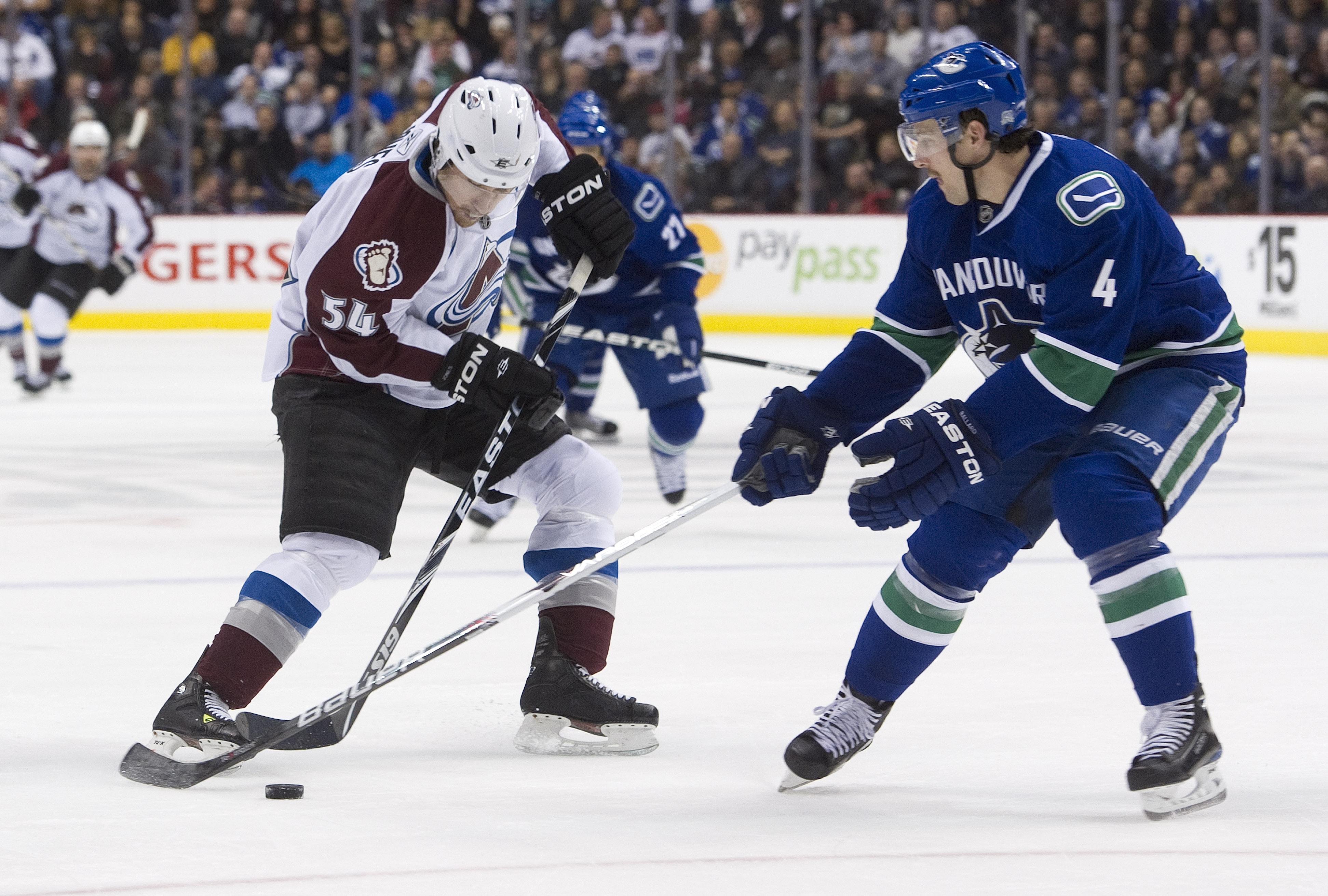 VANCOUVER, CANADA - NOVEMBER 24: David Jones #54 of the Colorado Avalanche tries to makes a move to get past Keith Ballard #4 of the Vancouver Canucks during the third period in NHL action on November 24, 2010 at Rogers Arena in Vancouver, British Columbi