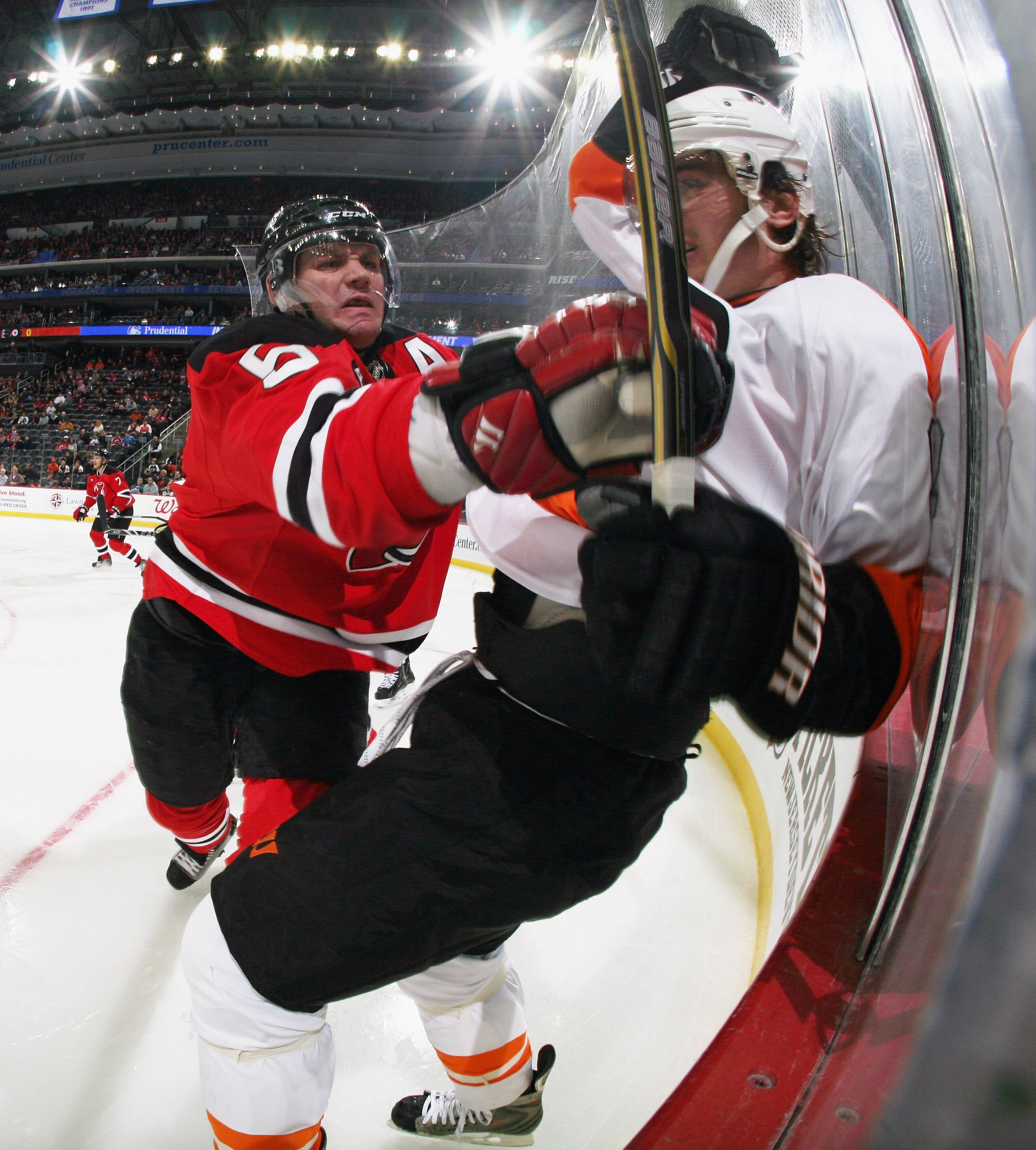 NEWARK, NJ - NOVEMBER 27: Colin White #5 of the New Jersey Devils hits Nikolay Zherdev #93 of the Philadelphia Flyers at the Prudential Center on November 27, 2010 in Newark, New Jersey.  (Photo by Bruce Bennett/Getty Images)