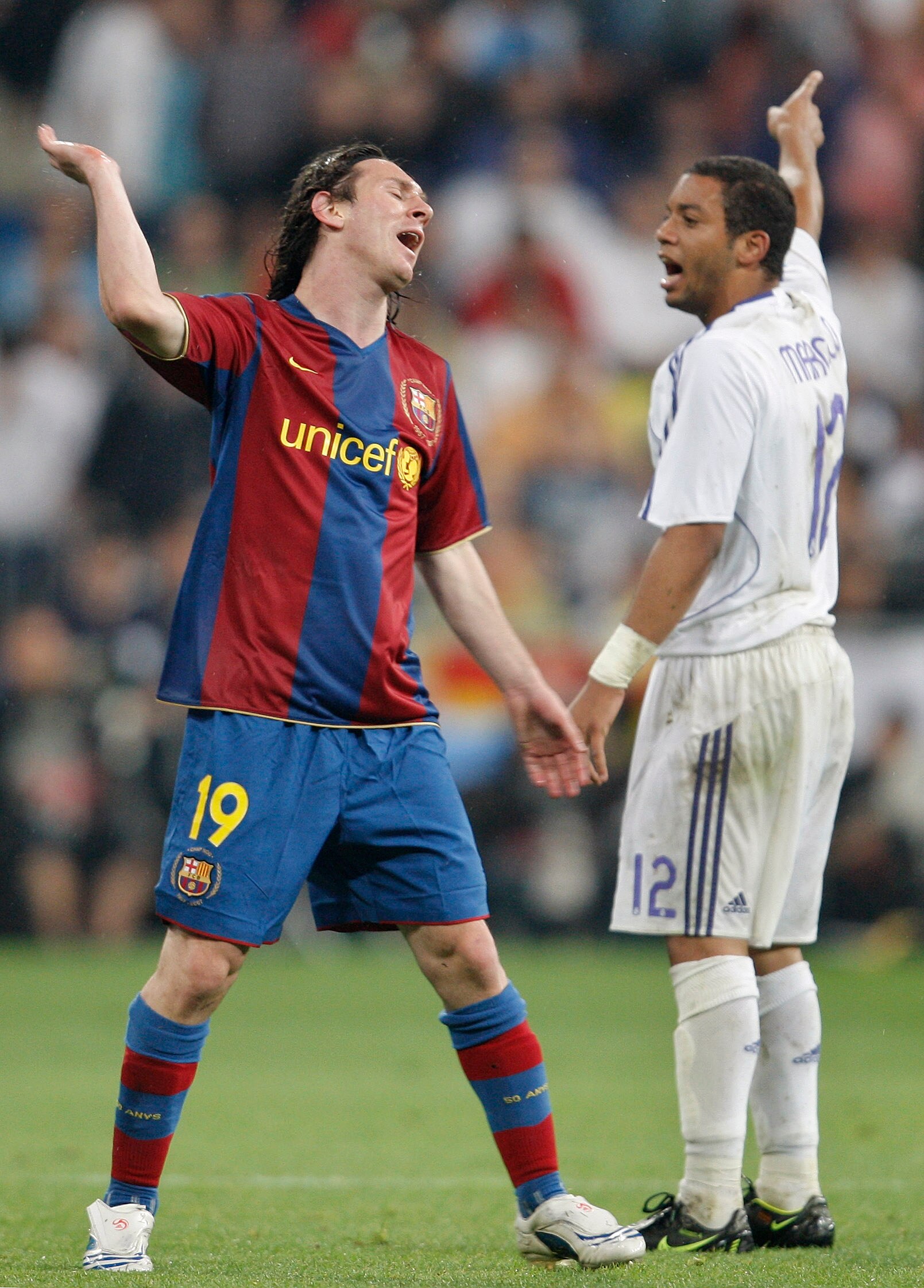 MADRID, SPAIN - MAY 07:  Lionel Messi (L) of Barcelona reacts flanked by Marcelo of Real Madrid during the La Liga match between Real Madrid and Barcelona at the Santiago Bernabeu Stadium on May 7, 2008 in Madrid, Spain. Barcelona lost the match 4-1.  (Ph